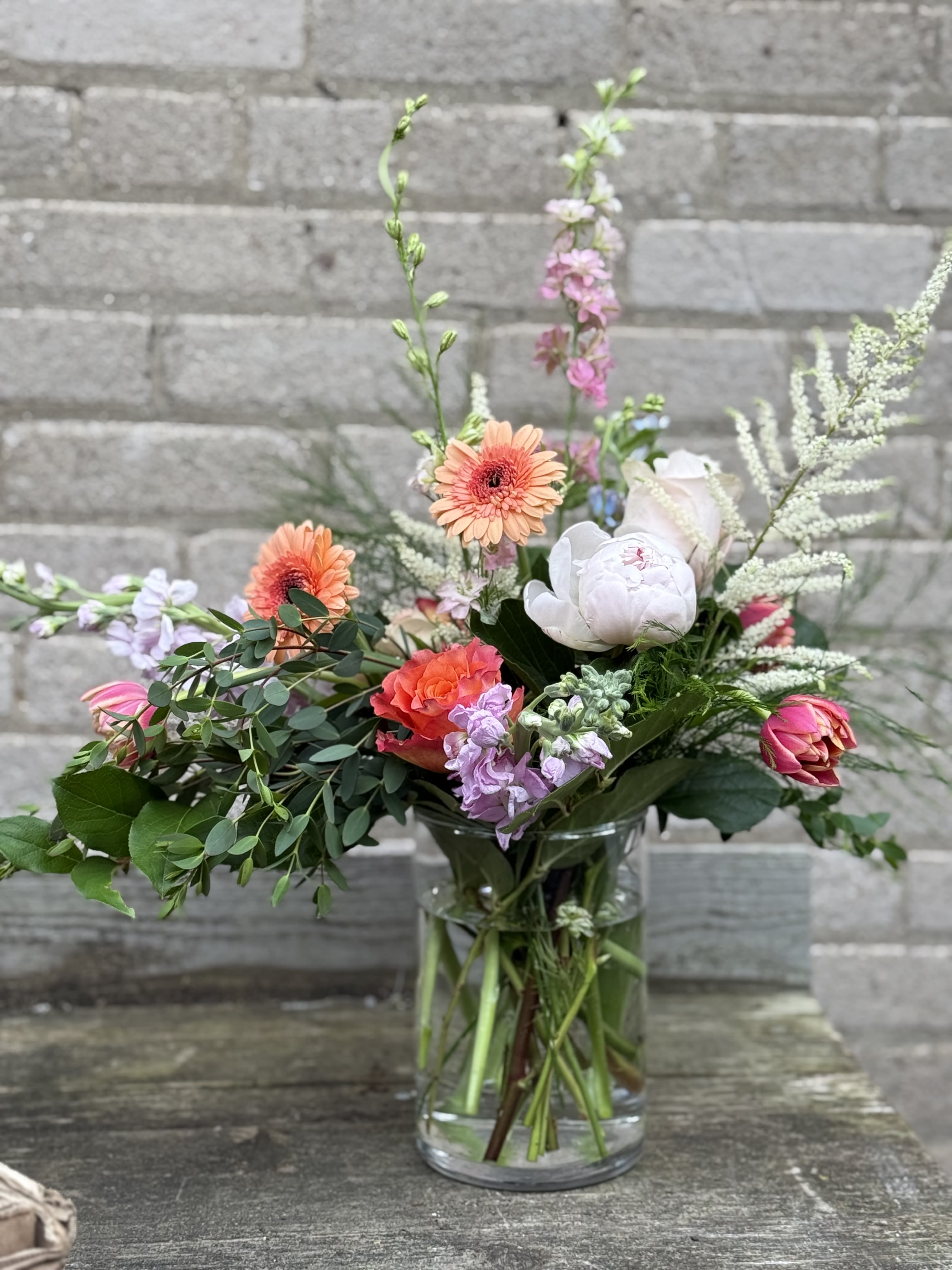 Spring Design - A beautiful designers choice, flowers may look different but the design will follow the photo’s lines We will use locally grown blooms as much as possible