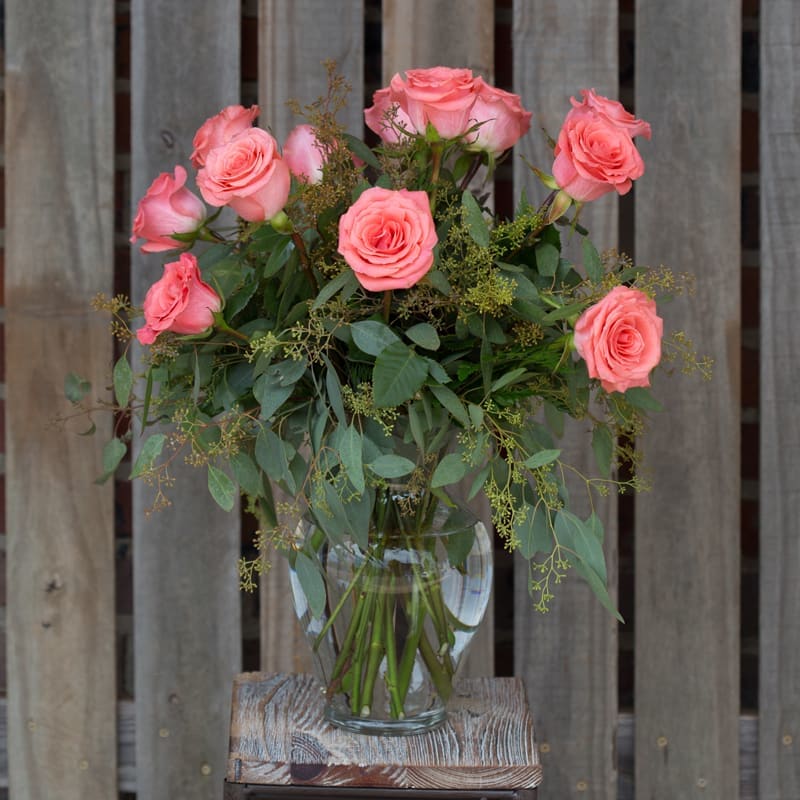 Coral Charm Coral Charm - Beautiful coral roses expertly designed in a glass vase!
