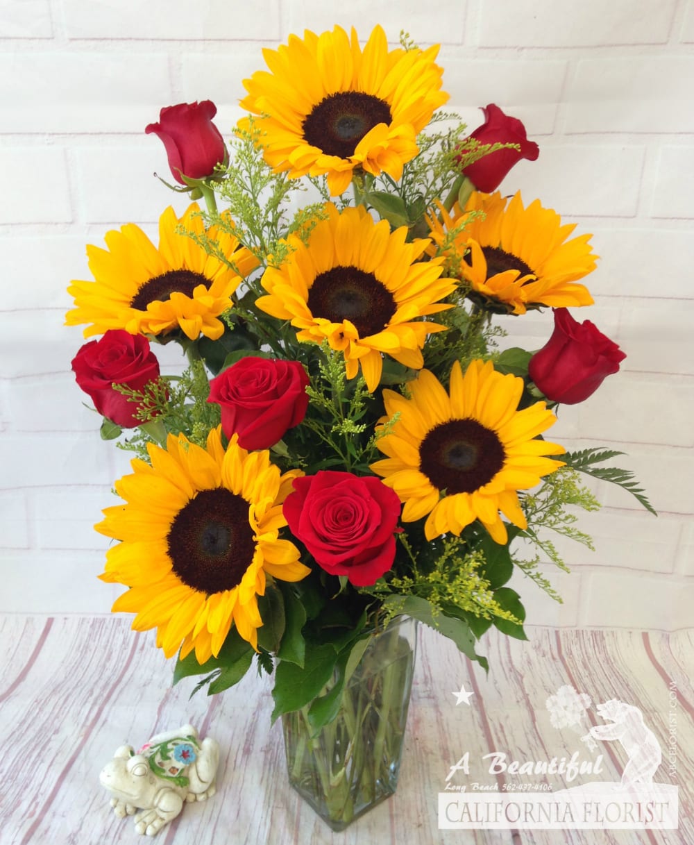 Yellow and Red Yellow and Red - Bright sunny Sunflowers paired with beautiful RED roses (or color of your choice, let us know in special instructions if you prefer another color rose). Then beautifully arranged by our artisan florist with lush greens and accents in a glass vase. Yellow and Red - Beautiful Sunflowers and Roses from A Beautiful California Florist in Long Beach, CA a five 5 star premier flower shop offering same day delivery.