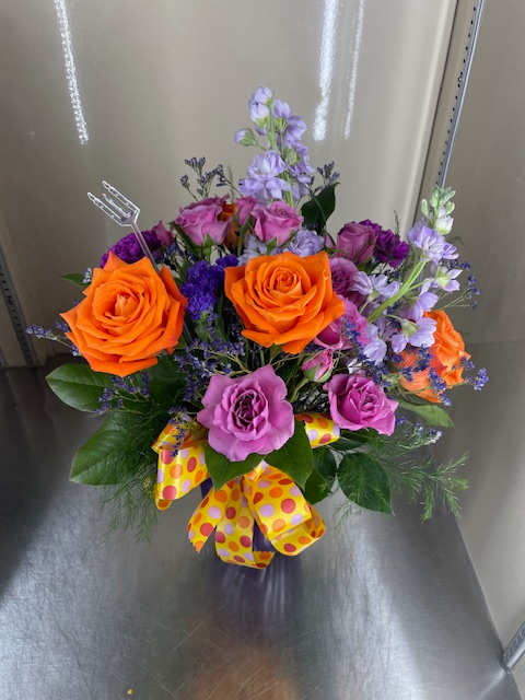 Sweet Abigail - Mixed cut flowers with orange roses, lavender stock, purple carnations, purple spray rose, and purple limonium in a vase with a bow.