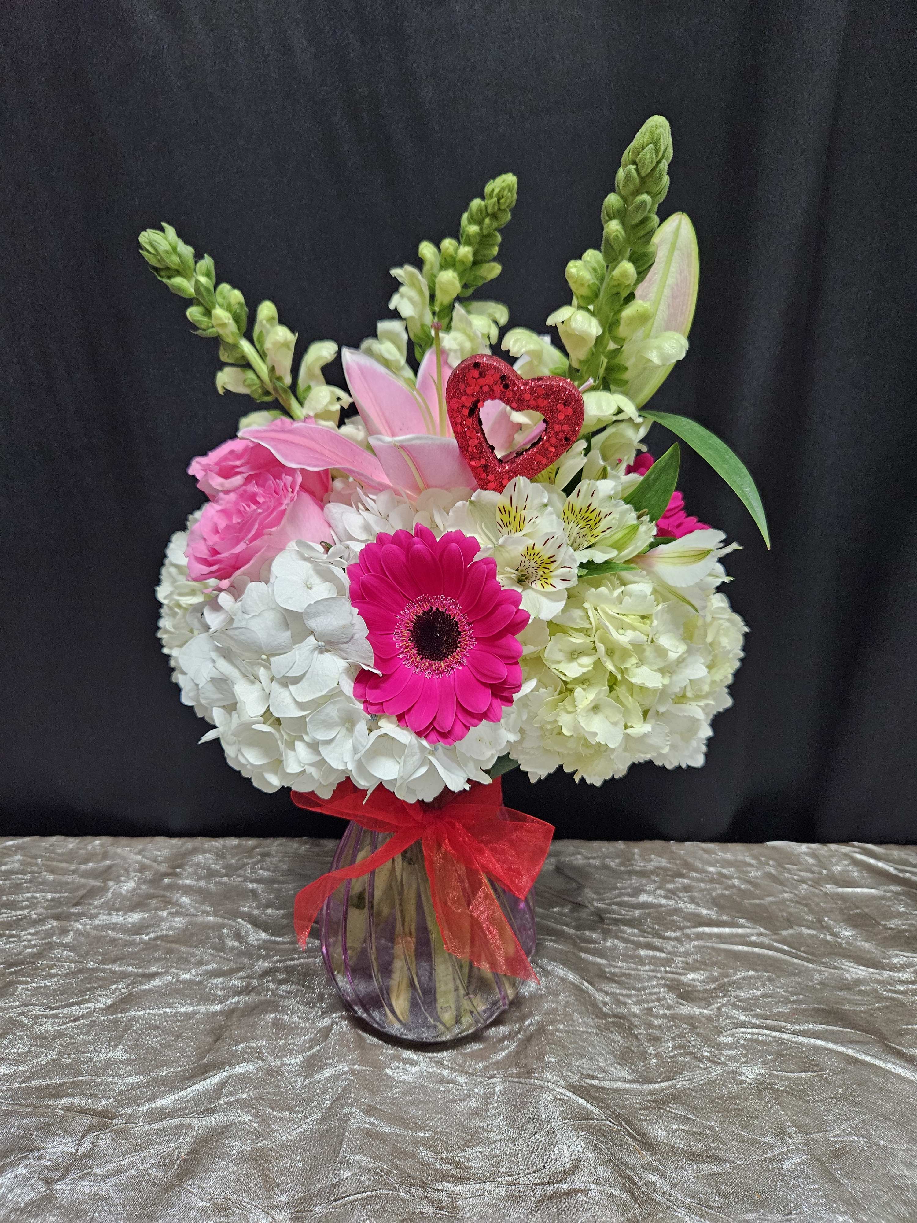 Vibrant Bliss - A little goes a long way with this arrangement. Each flower stands out with a bright pop of color among antique hydrangeas. It's perfect for brightening their day- just because!  