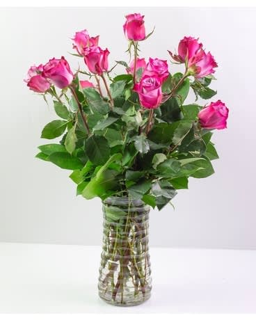 Dozen Purple Roses - Brighten their day with a dozen Purple Roses.   Please Note: There are 14 varieties of lavender to purple-colored roses. The color variations in roses, even on the same plant, are due to genetics and environmental factors. We may not always be able to guarantee a specific color of purple, as flowers grow depending on nature’s design! Some varieties of purple roses could have accents of white and/or pink.