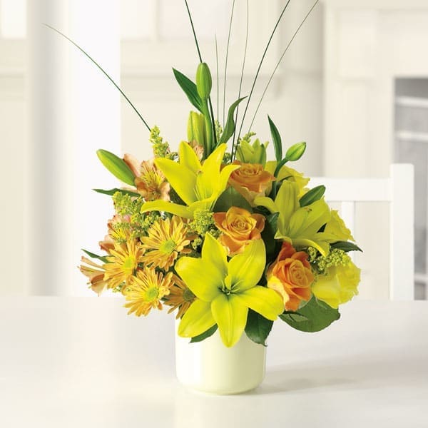 Sunshine Splendor Sunshine Splendor - Bright-yellow lilies and fire-orange roses awaken the senses with sunny greetings for any occasion. Brighten someone's day today!