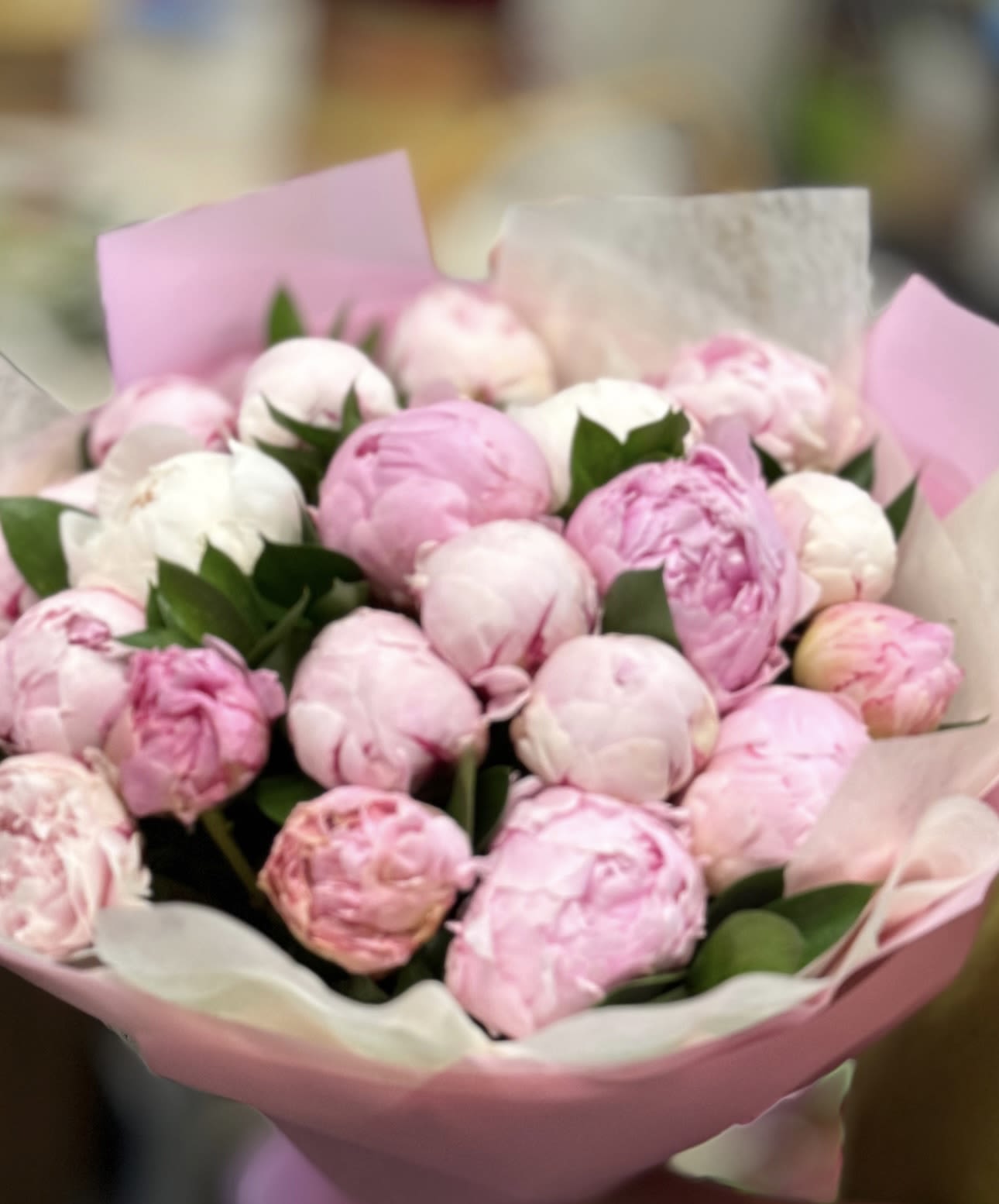 Peony Dreams -25 Stems - A luxurious bouquet of 25 fresh peonies in soft shades of blush and powder pink,delicately wrapped in layers of blush and pink papers. This bouquet radiates romance and grace.