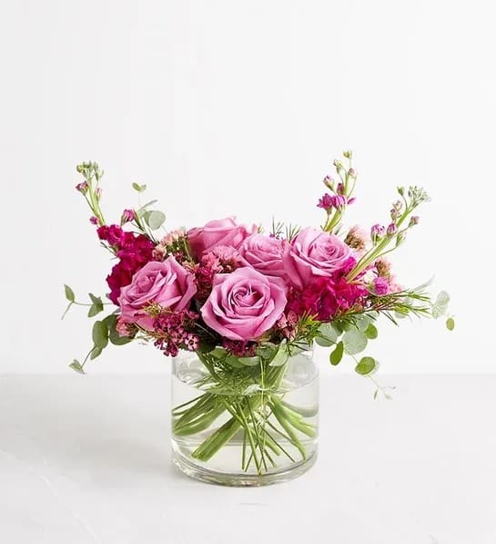 Lavish in Lavender Bouquet - All-around arrangement of lavender roses, fuchsia stock, purple waxflowers, pink statice, and greenery