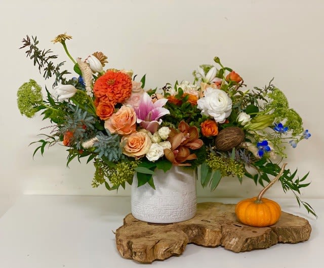 Pumpkin Farm Pumpkin Farm - Theme Colors: Shades of Orange, white, brown and green Featured Blooms: Roses, Orchids, Delphiniums, Stargazers, Ranunculus, Zinnias and greens HK Flowers have a uniqueness of florals and seasonal blooms, certain flowers or colors may not be available as each season affects the availability, color, size, and shape of each floral bloom. Some flowers may be substituted accordingly. Photos are used as a reference for the color palette and is NOT indicated of the final product. We ask for your trust in us that we will pick out the best seasonal available blooms, while still capturing the arrangements theme and colors mentioned above.