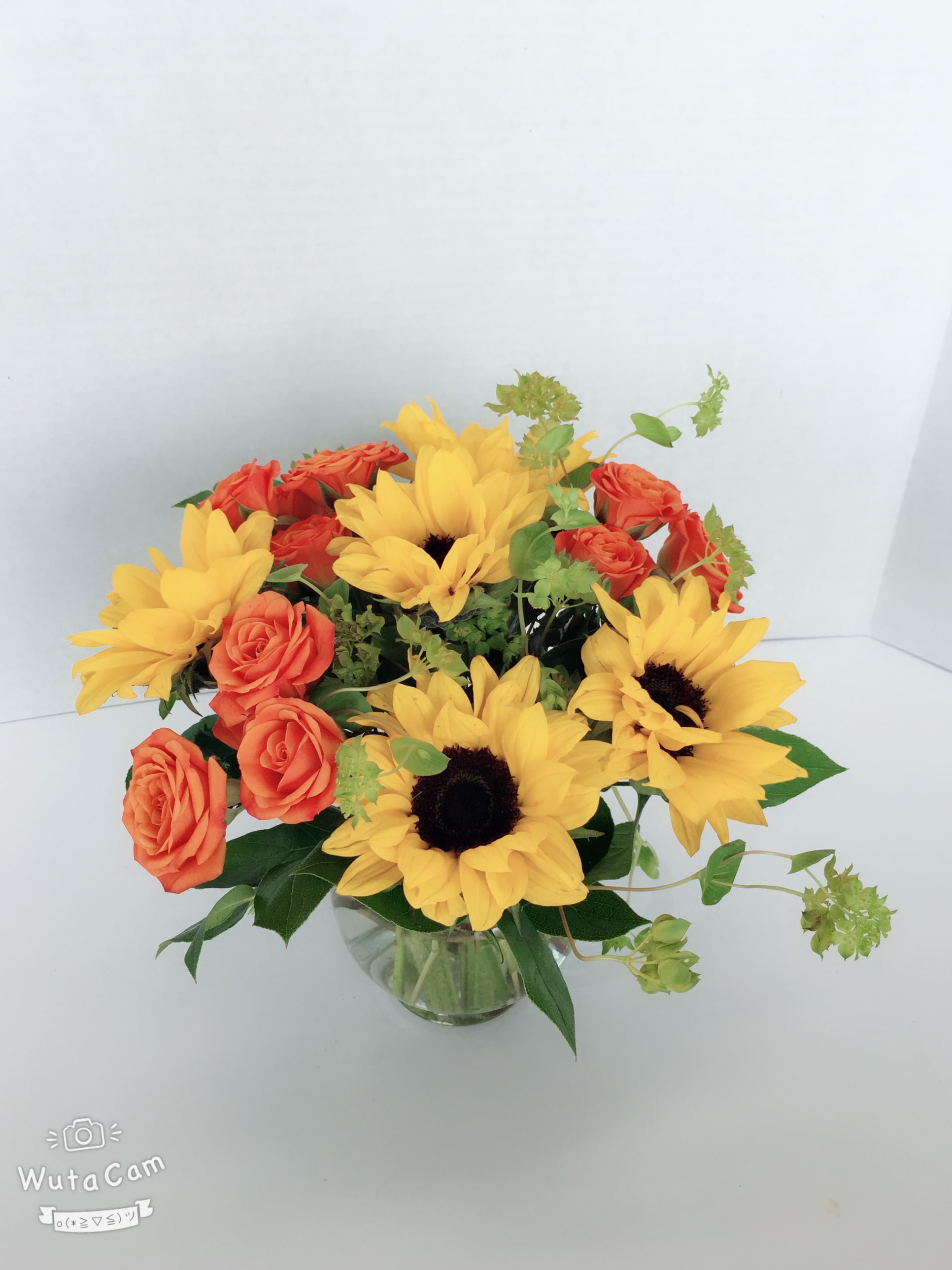 Happiness Bouquet - Pure happiness is what this pretty bouquet delivers - whether you're sending it for birthday, thank you, or simply just because Sunny sunflowers, orange roses and Bupleurum with greens are beautifully arranged in a clear glass vase.  Approximately 13 1/2&quot; W x 16 1/2&quot; H  Orientation: All-Around