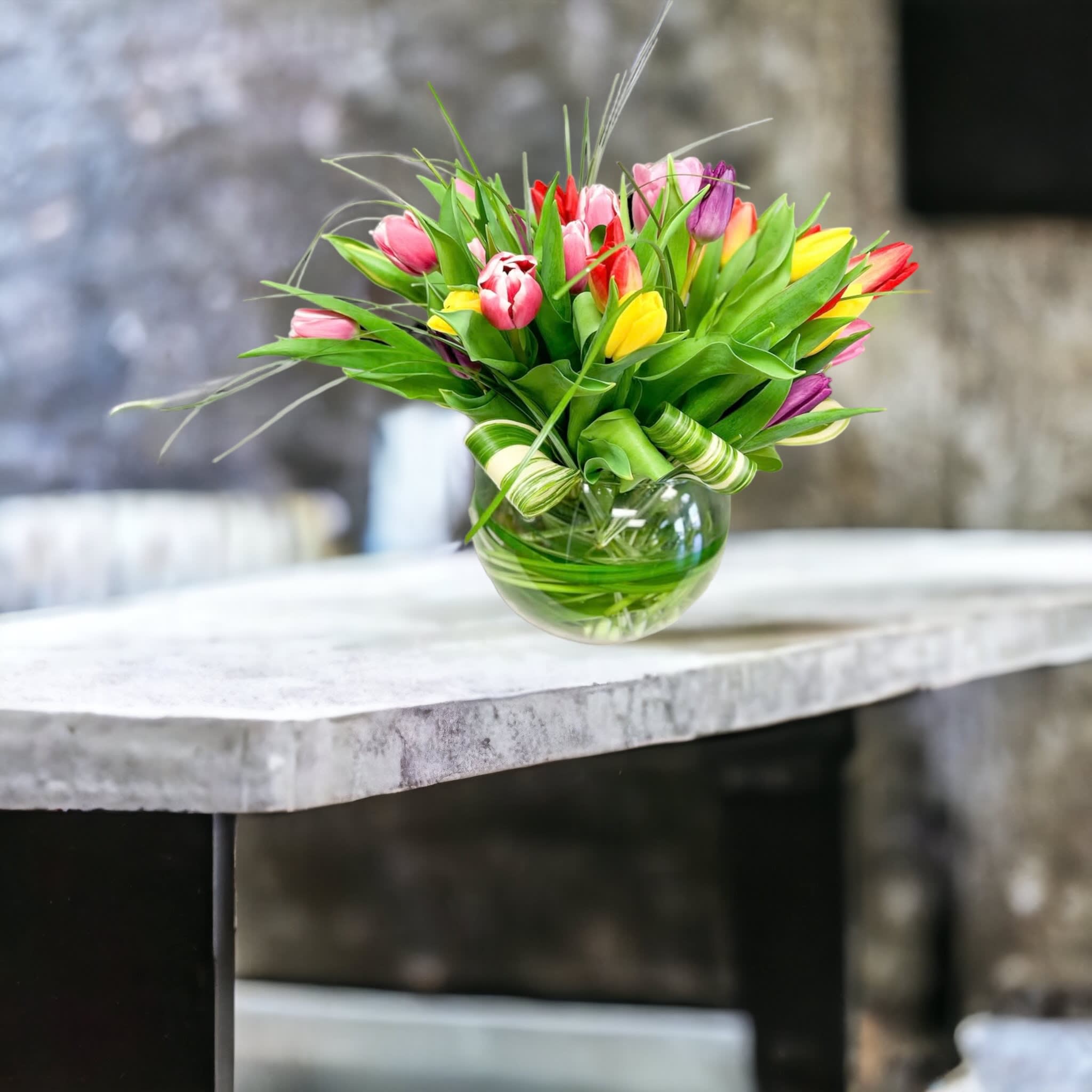 Tulip Explosion - Send Tulip Explosion and let them know spring has sprung. Design includes thirty Mixed tulips, variegated greens and bear or lily grass. Tulip colors may vary depending on availability. 