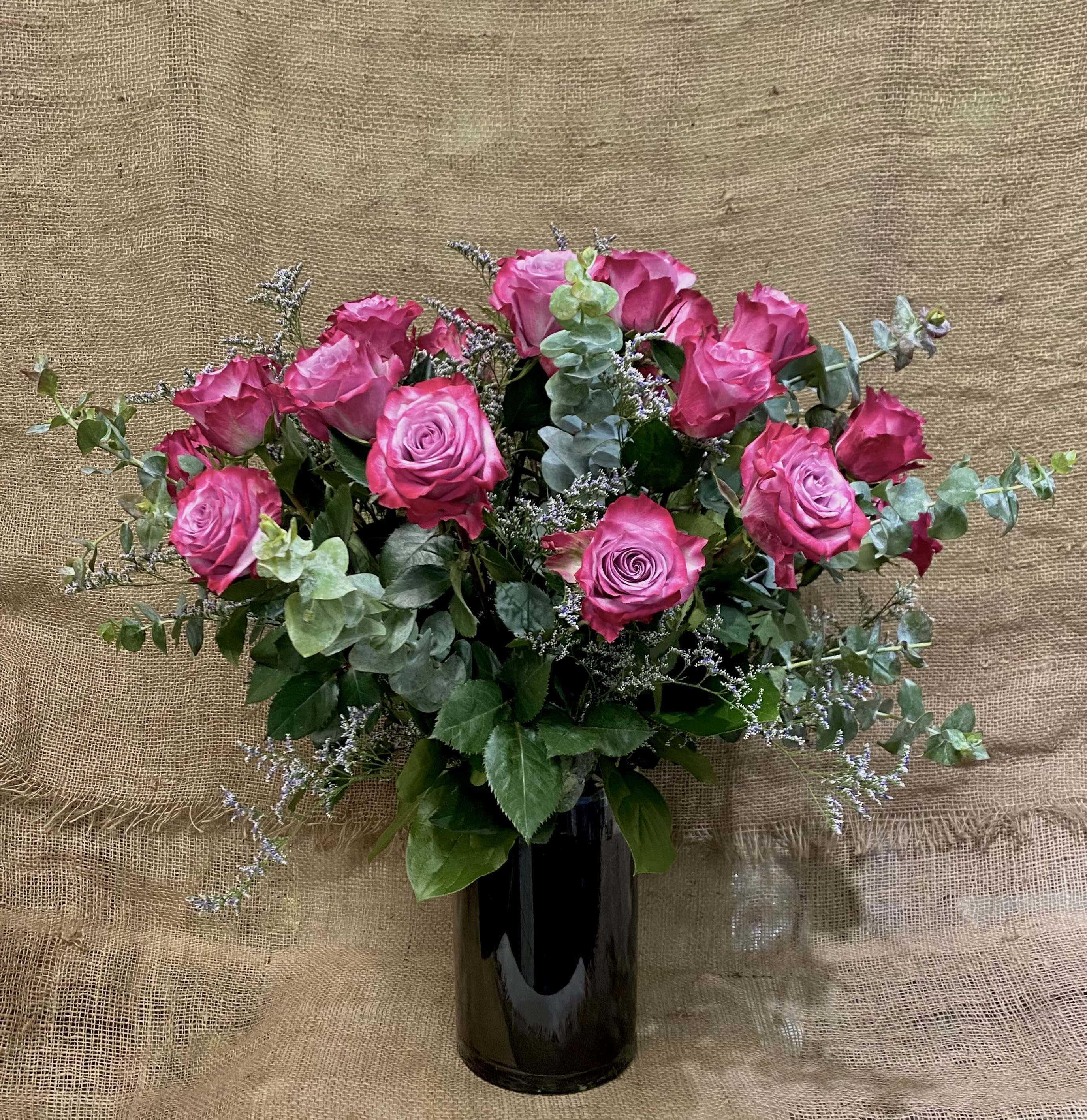 18 Purple Roses 18 Purple Roses - a dozen and a half deep purple roses in a black glass vase