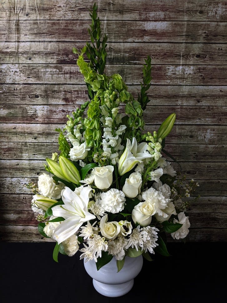 FUNERAL FLOOR SPRAY - Morning Dew 15 - This is a classic and elegant option for a memorial or funeral service. This arrangement is an “A” shaped one sided flower arrangement that stands approximately 3.5' tall and 1.5' wide. This lovely mix of white flowers of roses, lilies, daisies and bells of Ireland is the perfect way to send your condolences.  **This is a piece for a funeral or memorial service. Please place the order at least 2 days prior to the service to guarantee a certain arrangement. Anything sooner and we cannot guarantee it will match the picture. These pieces can be customized to the color of your choice. The flowers may vary depending on availability of the flowers, special requests and quality of the flowers we have in stock. If you have a special request please add it to our special instructions when placing your order. If you have any questions please don’t hesitate to call. 714 289 1123**