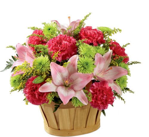 Soft Persuasion Bouquet - Blossoming with a blushing grace and casual appeal your recipient will adore, this fresh flower arrangement will persuade them to see the beauty of all that surrounds them. Pink Asiatic Lilies are the star of this bouquet surrounded by hot pink carnations, pink roses, green button poms, and lush greens, arranged to perfection in an oval woodchip basket to give it a chic country garden styling. A lovely way to say thank you, get well, or congratulations!