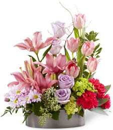 Favorite Blooms Favorite Blooms - Roses and tulips and Asiatic lilies - oh, my! All your favorites are here, arranged in a shallow pot in pretty pastel colors. This flower arrangement is a wonderful way to welcome a new baby, cheer up someone you love or brighten your own entryway. Also, a great housewarming gift! Lavender roses, pink tulips, pink lilies, red carnations, lavender daisy mums and green button mums are arranged with seeded eucalyptus and Spanish moss in a shallow planter.
