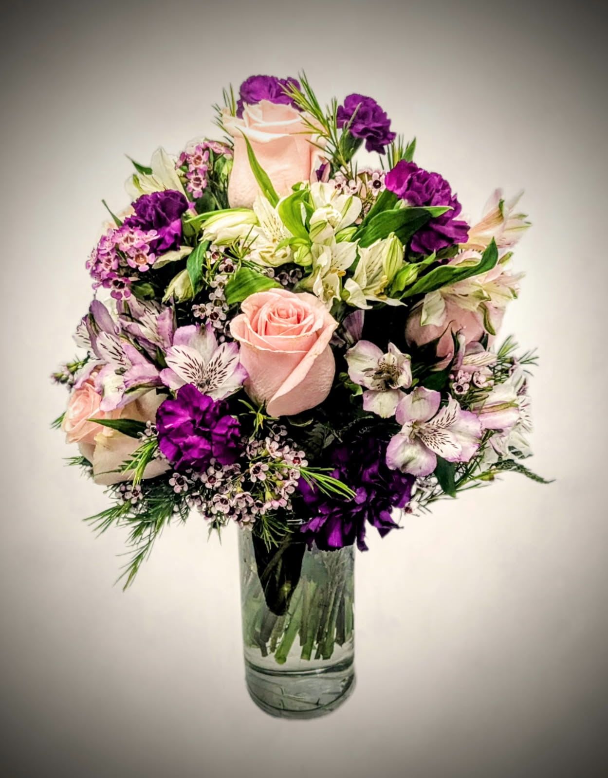 Lavender Grace bouquet Lavender Grace bouquet - Soft, romantic, and full of charm, the Lavender Grace Bouquet features a graceful blend of blush pink roses, deep purple blooms, and delicate white accents. Artfully arranged in a clear glass vase, this bouquet brings a touch of calm sophistication to any space. Perfect for birthdays, celebrations, or simply to brighten someone’s day with beauty and elegance.