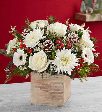 WOODSY WINTER WOODSY WINTER - PINE WOODEN CUBE WITH NATURAL EVERGREENS AND A SNOWY WHITE ASSORMTNET OF WINTER FLORALS ADORNED WITH PINECONES