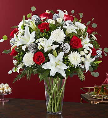 ELEGANT CHARM VASE ELEGANT CHARM VASE - ELEGANT ASSORTMENT OF HOLIDAY CHEER- FEATURING PINE CONES EVERGREENS AND WHITE ORIENTAL LILLIES