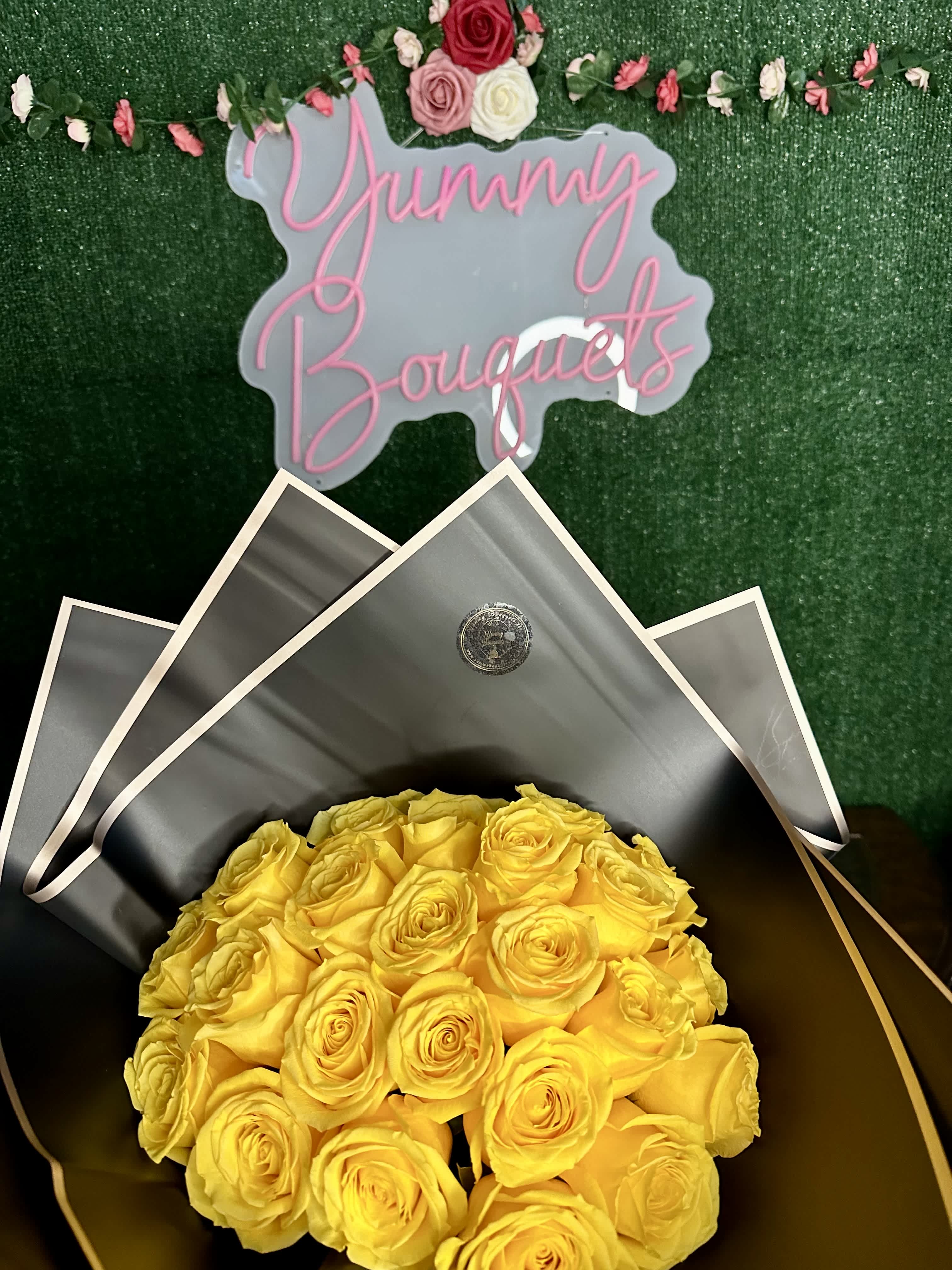 Sunny Buchon Sunny Buchon - Standard 24 roses Deluxe 35 Roses Premium 50 Roses "Picture is a reference every arrangement would not be exactly the same. Color Substitution may apply. Flowers and color substitution may apply