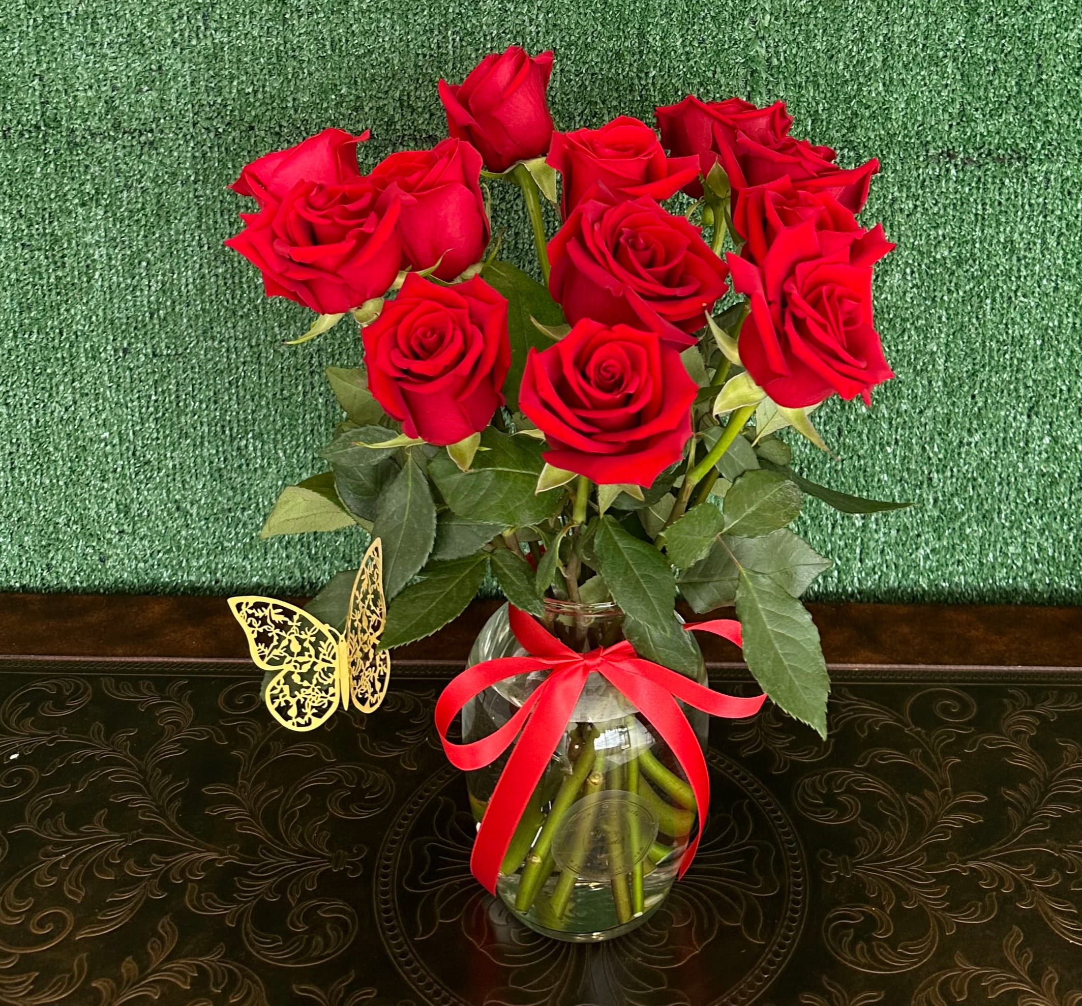 Classic dozen Classic dozen - Standard Dozen roses in a clear vase. Premium 18 Roses Deluxe 24 Roses "Picture is a reference every arrangement would not be exactly the same. Color Substitution may apply. Flowers and color substitution may apply"