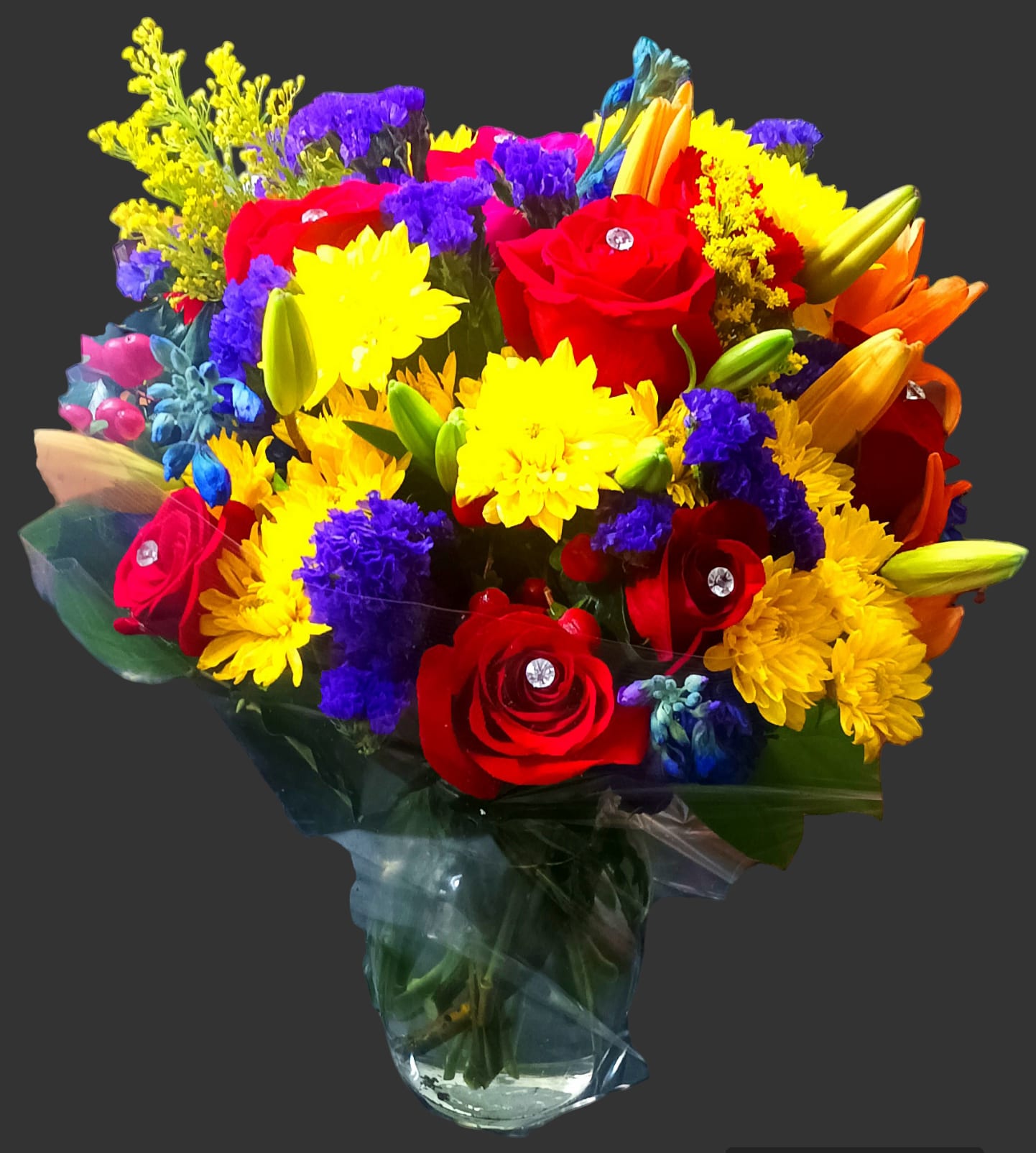 Good value mixed floral vase with diamonds - This is very beautiful and inexpensive and has diamond pins in the roses. It's a very beautiful floral gift, with red roses, fuschia roses, red carnations, purple statice, yellow cushion daisies, orange lilies, yellow solidago fillers, lemon leaves, and purple stock flowers. A lot of flowers in a beautiful vase.