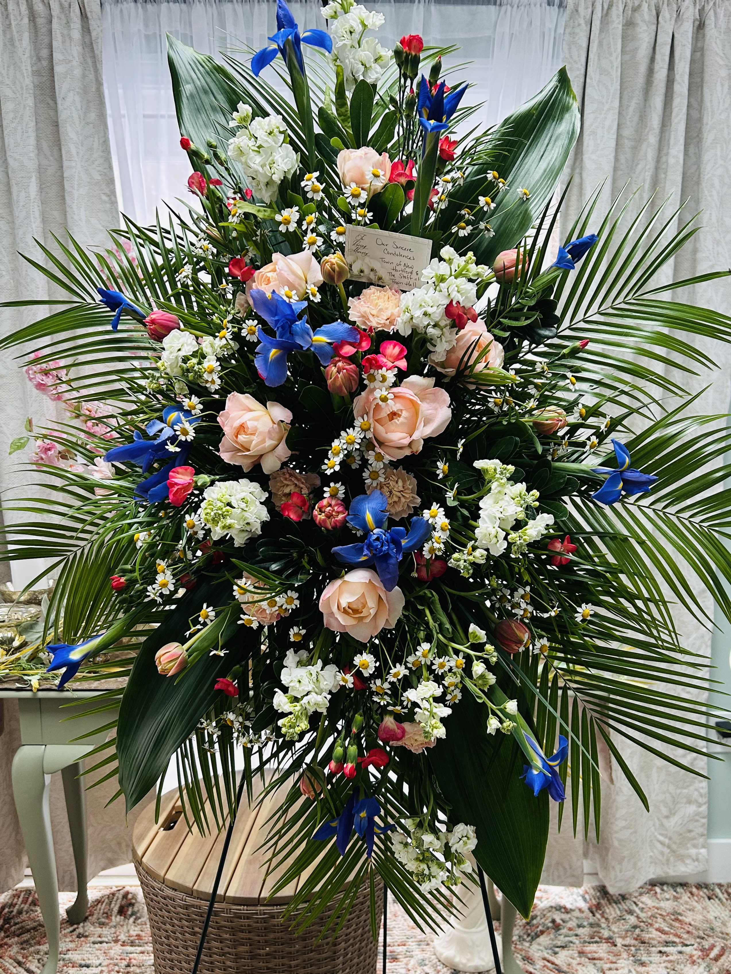 An honor to know you An honor to know you - A standing spray of larkspur, stock, iris, roses, mini carns, daisies, palm and ty leaves