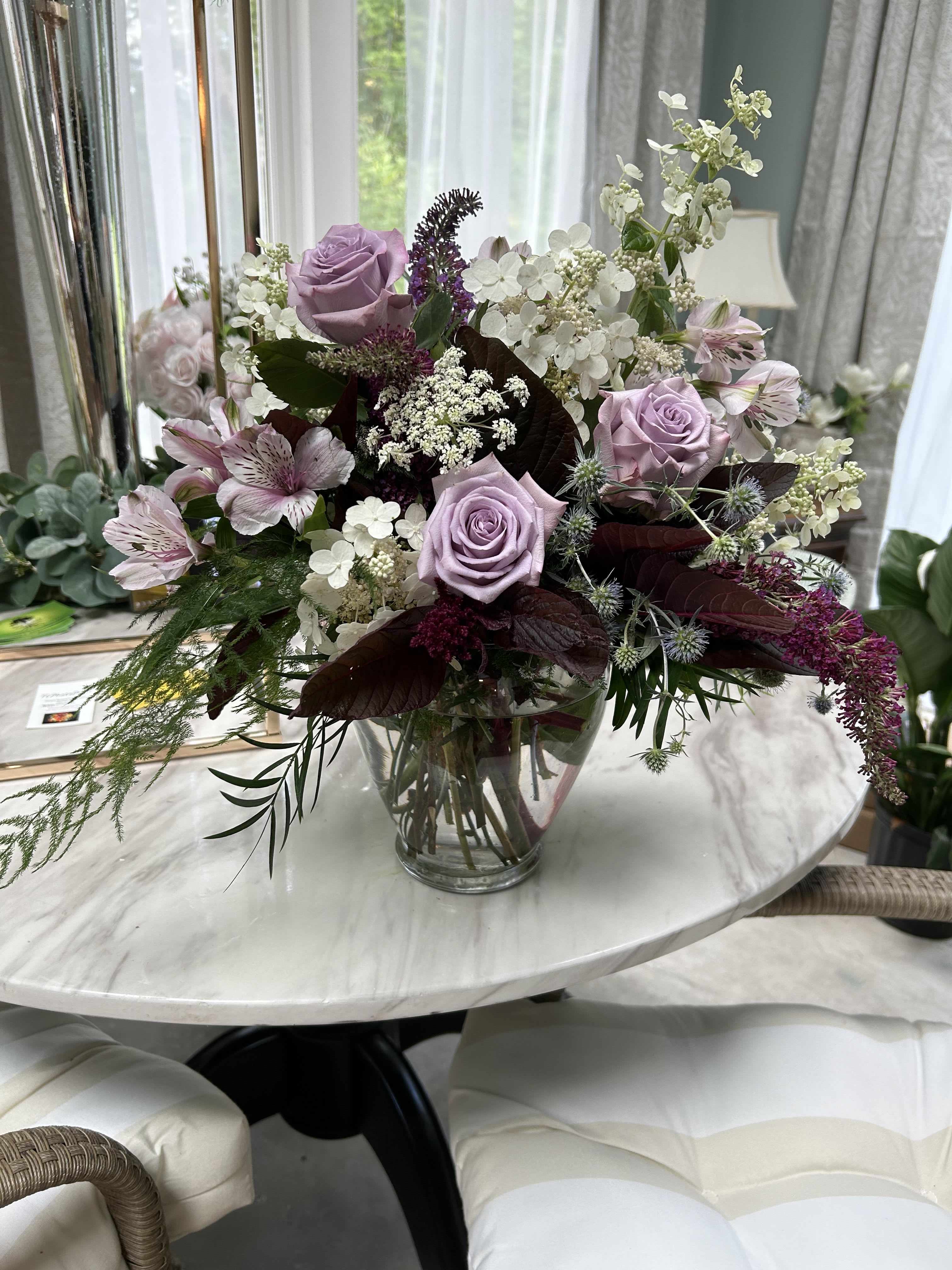 Enchanted evening Enchanted evening - This beautiful lavender and burgundy arrangement designed with , roses, alstromeria and queen annes lace. This picture has amaranthus which is only included in the premium option if availble. It can be substituted with dendrobium orchids as well.