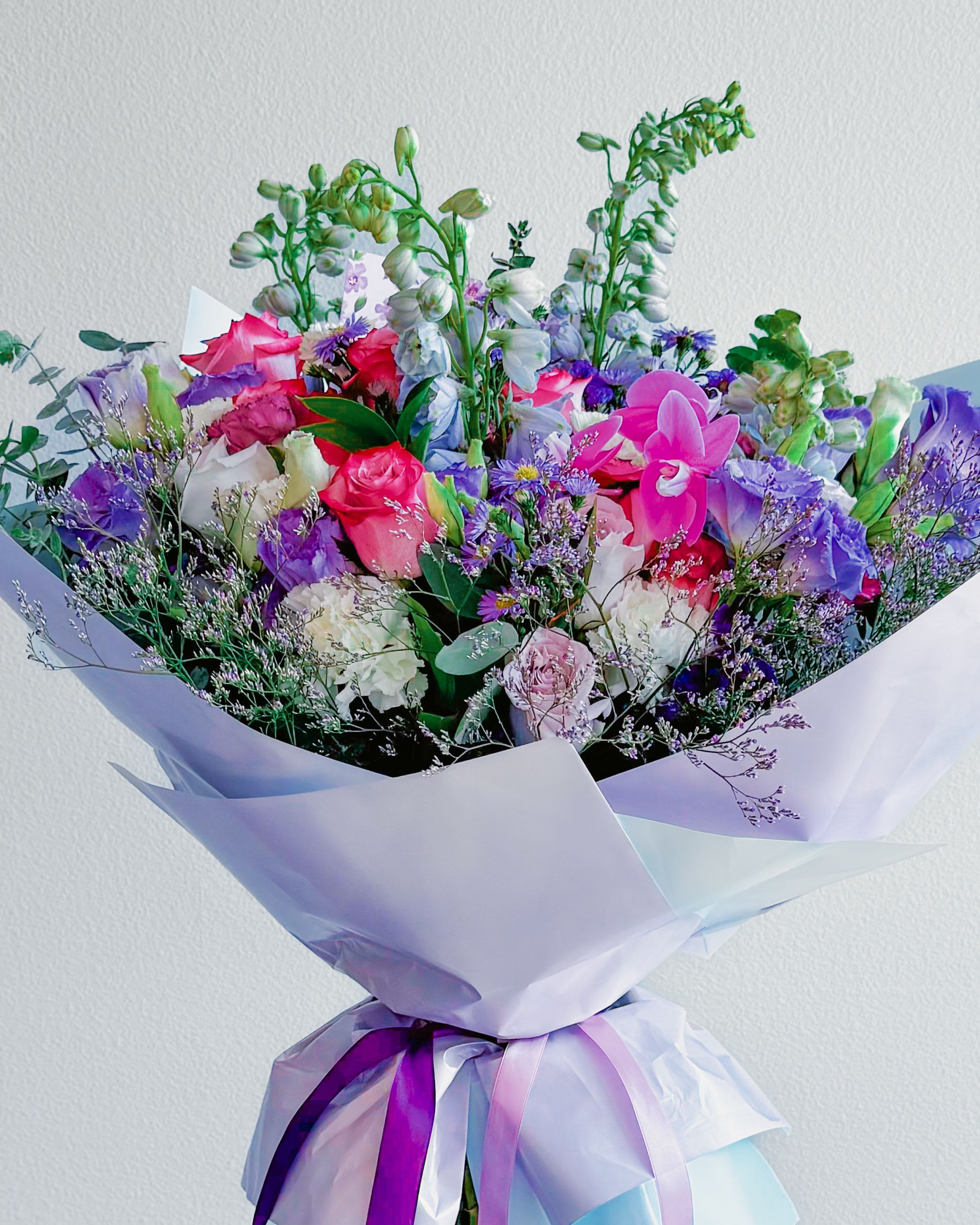 Lilac Letters - Meet Lilac Letters — a dreamy, pastel-packed bouquet that feels like a love note from a secret admirer. It’s soft, it’s flirty, and it’s got major vintage-core vibes. Think delicate lavender hues, poppin’ pinks, and creamy whites all wrapped up in a bouquet that looks straight outta your daydreams. Whether you’re saying &quot;miss you,&quot; &quot;thank you,&quot; or just feelin’ some kinda way — this one does the talking for you. It’s giving: handwritten letters, vintage stamps, soft sunlight through sheer curtains, and that one Taylor Swift bridge that still makes you cry.
