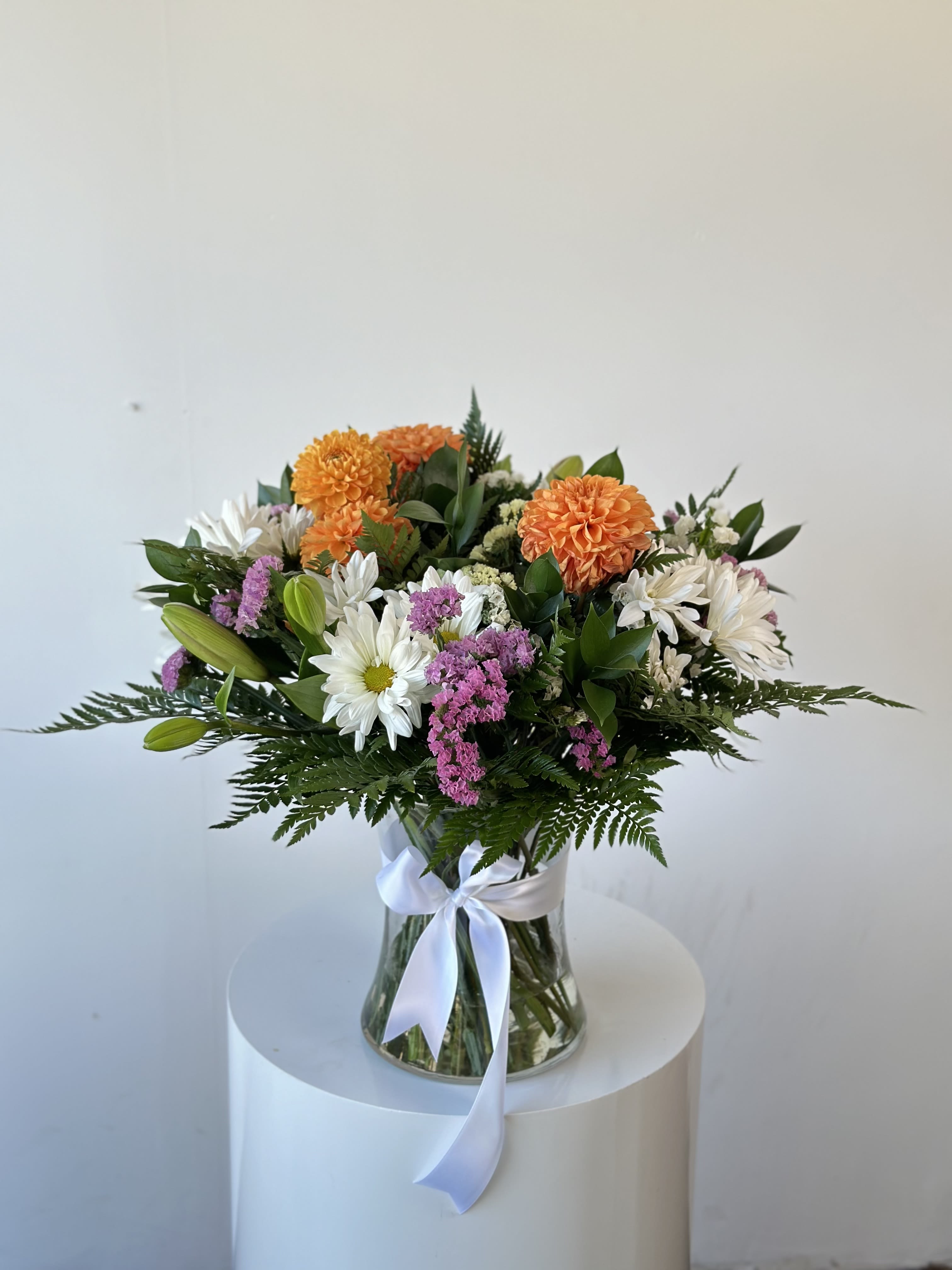 Vase Arrangement - Stunning assortment of fresh blooms!  Send this beautifully-curated design, mix of seasonal flowers in a tall glass vase. We kindly ask to add to the order notes your color preference for the arrangement. While we always try to follow your request of colors, we may sometimes need to use a different vase.  Arrangement includes: - Glass vase - Fresh seasonal mix flowers - Flower care instructions card - Greeting card