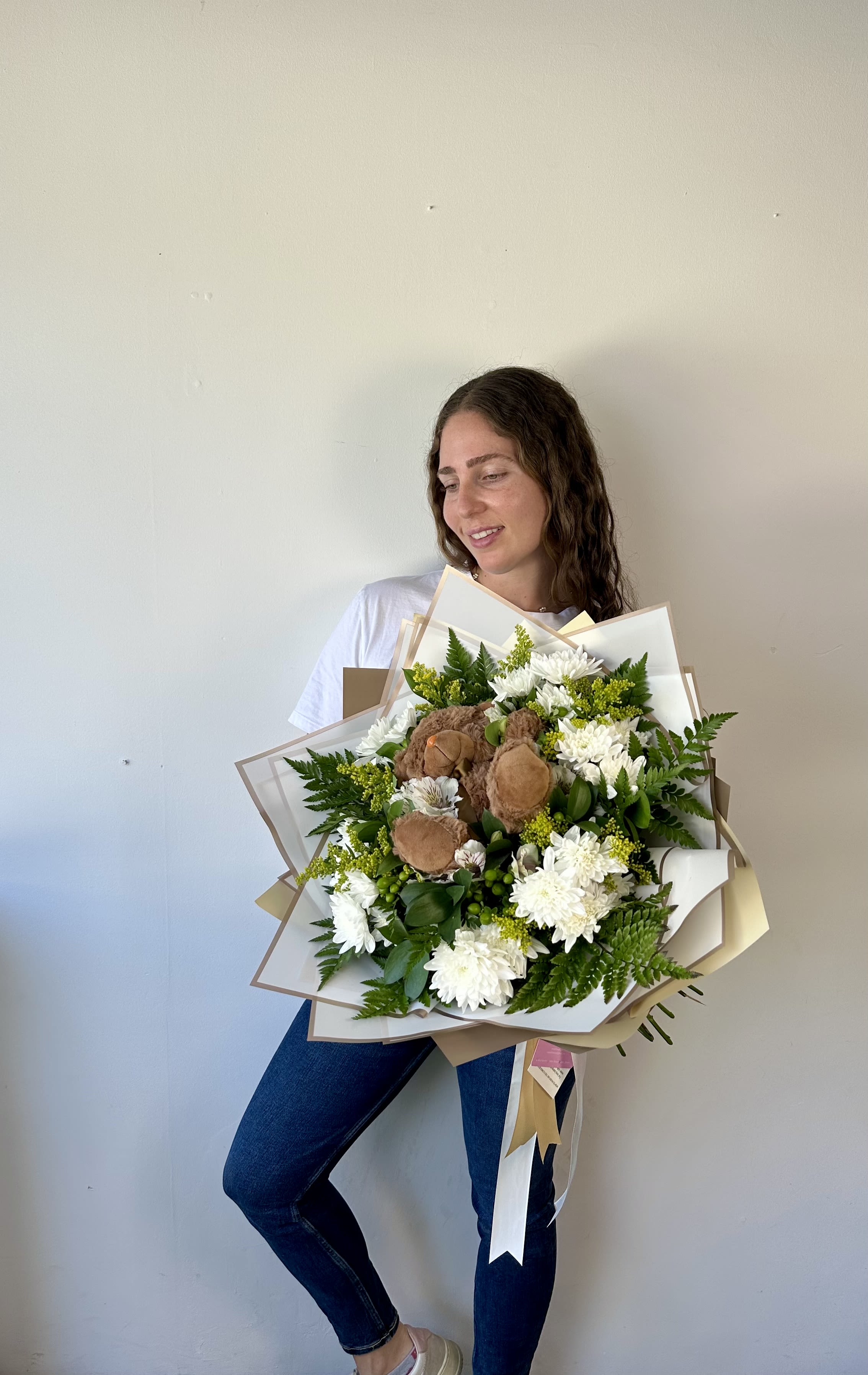Teddy Bloom Bouquet - A heartwarming blend of flowers and cuddles! Our Teddy Bloom Bouquet is a handmade floral arrangement featuring a soft, adorable teddy bear nestled in the center. Perfect for welcoming a newborn or simply expressing love. This bouquet adds a unique and memorable touch to any occasion.  Choose your preferred flower colors to create a personalized gift that truly speaks from the heart.  Sweet, special, and one-of-a-kind. It’s more than flowers, it’s a hug in bloom!  Arrangement includes: - Fresh roses - Teddy bear - Wrapping papers - Flower care instructions card - Greeting card