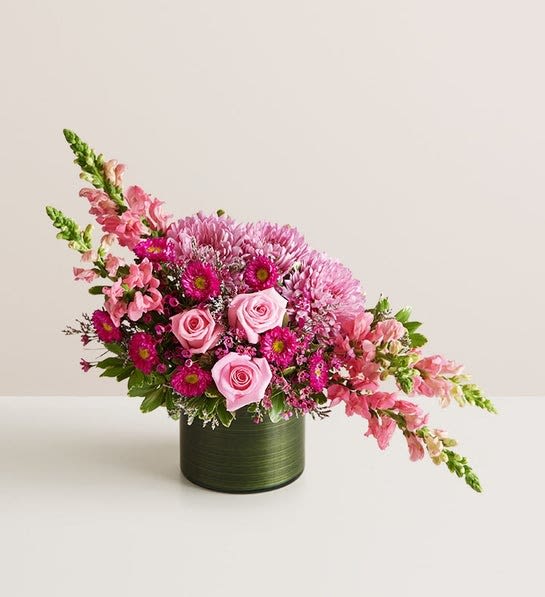 Charmingly Chic Bouquet - NEW This statement-making bouquet will dazzle even the most difficult to impress. Lavish blooms—roses! snapdragons! Matsumoto asters!—are arranged to create a dramatic linear silhouette. Please note that because this is a one-sided arrangement, no flowers are visible from the back. 