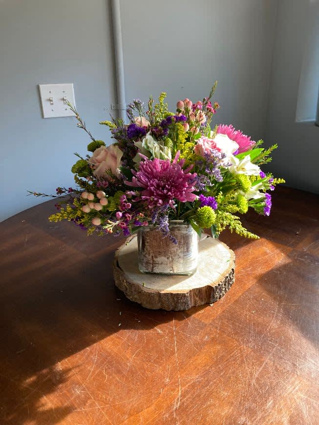 Fun and Cheerful - all round arrangement in a square cube with alstromeria,roses,lilies and carnations in vibrants hot pinks and oranges, greens and yellow