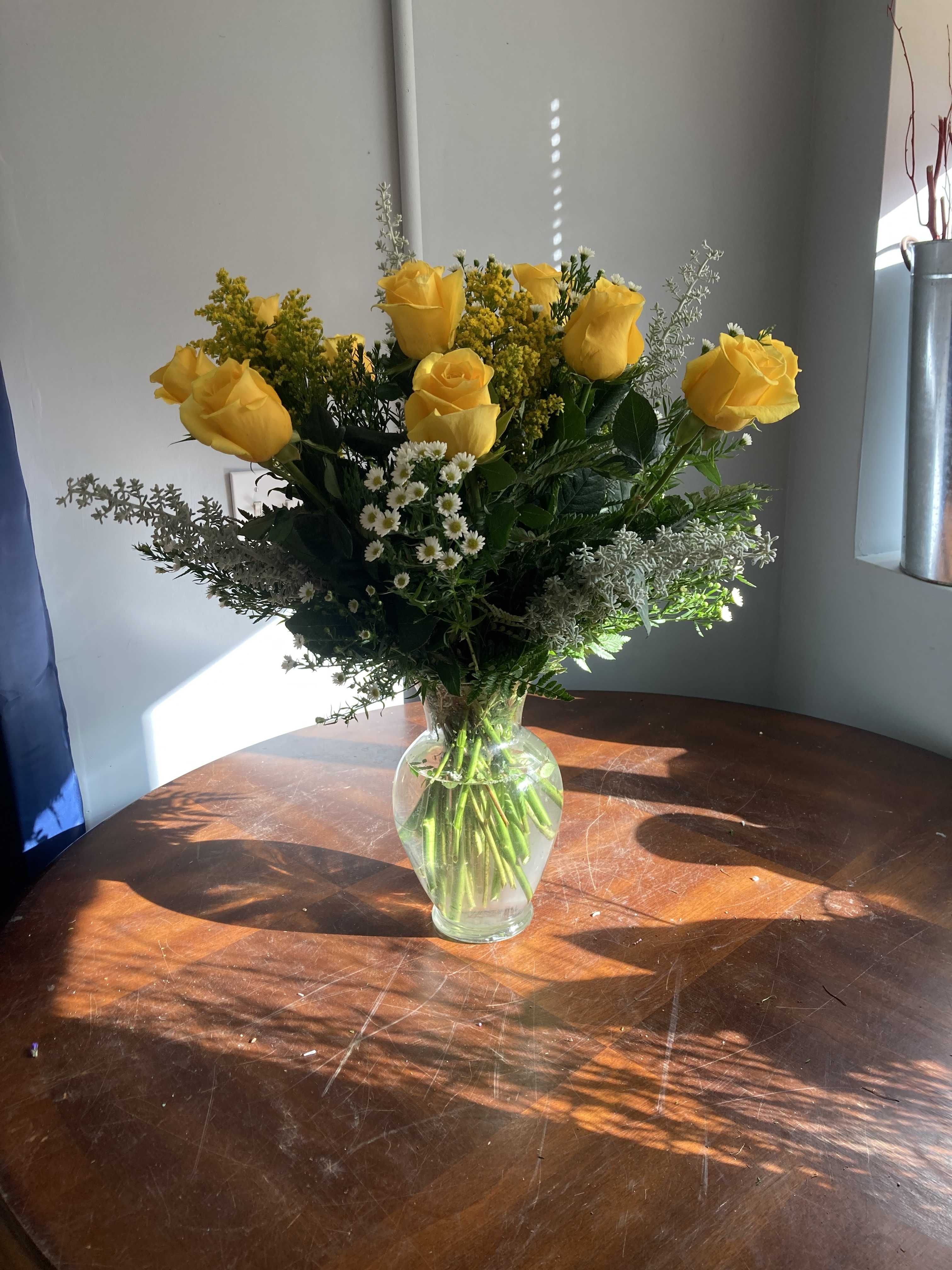 yellow rose - one dozen yellow roses in a vase with filler and greens
