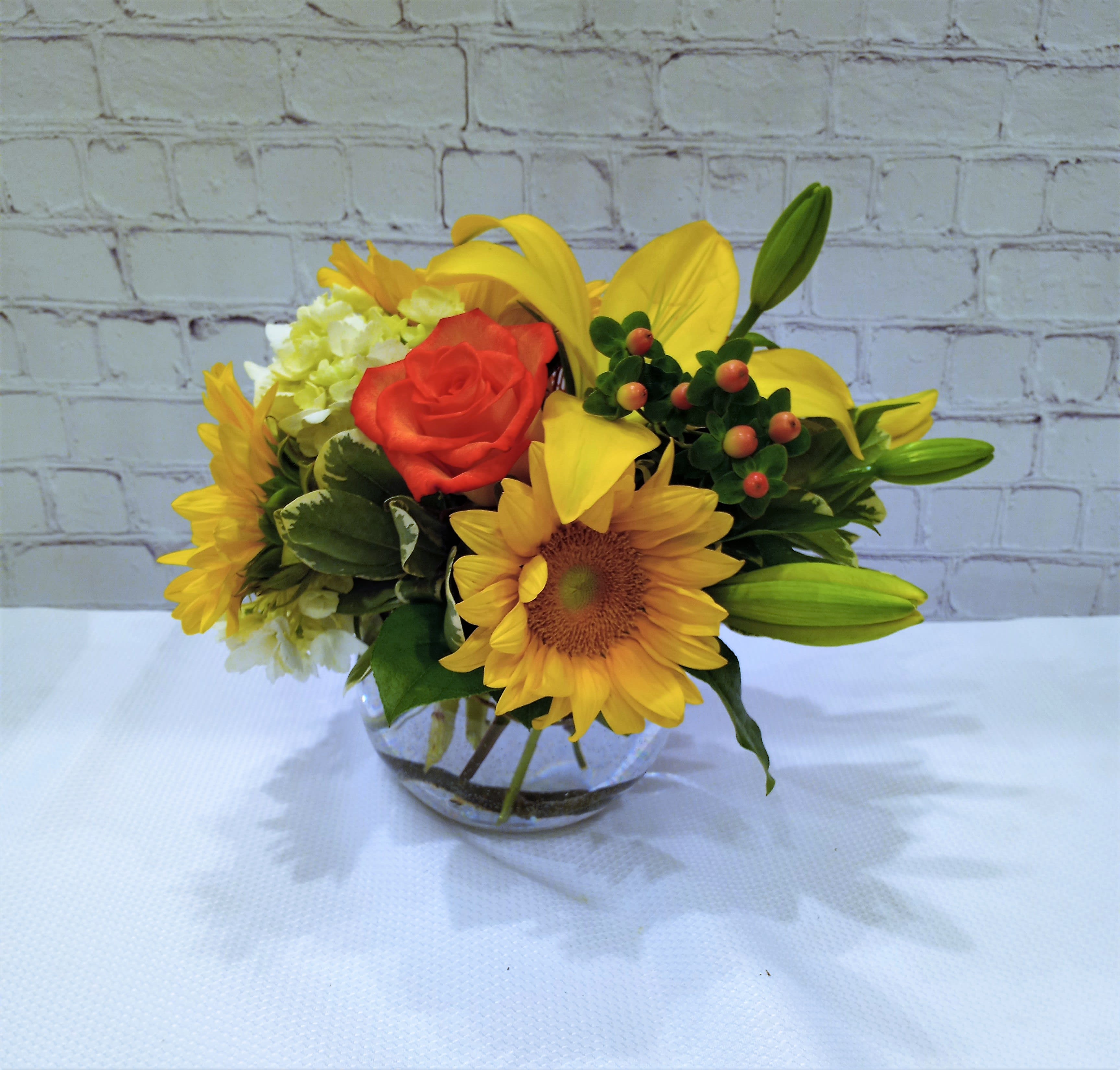 Bowl of Sunshine  - All time favorite at Metcalfe's.  Sunflowers, lilies, and hydrangea highlighting a tropical pincushion protea. 