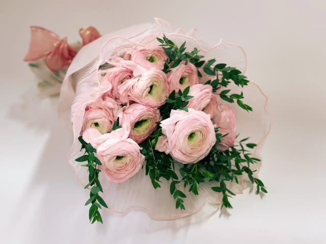 Wrapped Bouquet Of Ranunculus  - This beautiful wrapped bouquet by Venetian Flowers showcases the enchanting charm of pink ranunculus, known for their delicate layers and soft, romantic hues. Paired with the elegant parvifolia eucalyptus, which adds a touch of greenery and a subtle, fragrant aroma, this arrangement is a perfect blend of beauty and simplicity.  The ranunculus blooms stand out with their lush petals, creating a stunning focal point, while the eucalyptus provides a fresh, natural backdrop that enhances their allure. These gorgeous garden flowers are so striking on their own that they require minimal arranging—simply place them in a vase of water and let their beauty shine. This effortless bouquet is ideal for brightening up any space or gifting to someone special, bringing a touch of elegance and joy with every glance. Enjoy the simplicity and charm of nature with this delightful arrangement! Naturally these blooms have shorter stems - 30 to 40 cm 12-15&quot;  Standard - 10 Stems  Deluxe - 15 Stems Premium - 20 Stems 