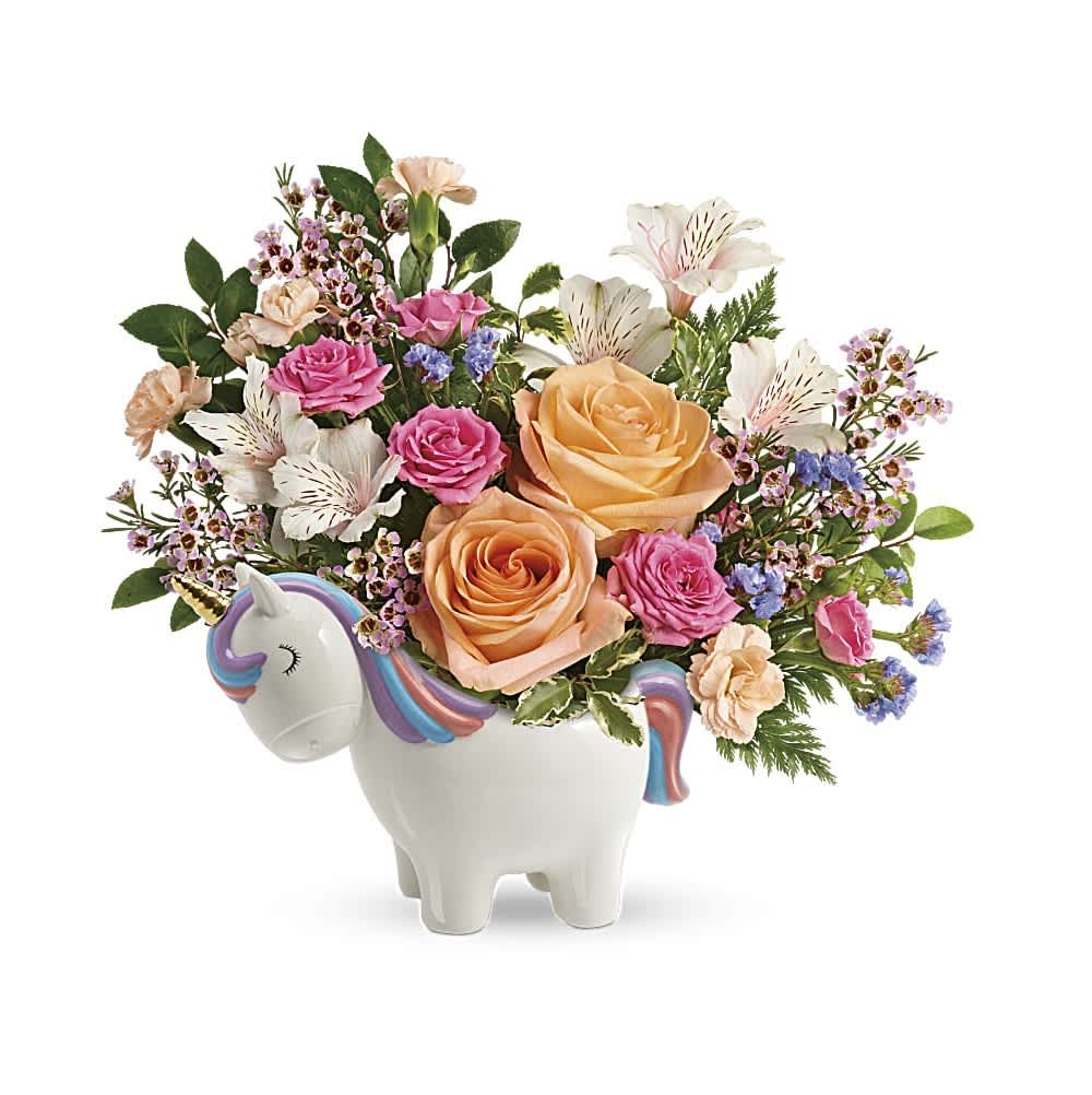Magical Garden Unicorn Bouquet - Make magic with this joyful gift of peach and pink roses, delicately arranged in this sweet ceramic unicorn keepsake that's hand-painted for an extra-special touch! Peach roses, pink spray roses, white alstroemeria, peach miniature carnations, blue sinuata statice, and pink waxflower are accented with huckleberry and pitta negra. Delivered in The Charmed Unicorn Keepsake.