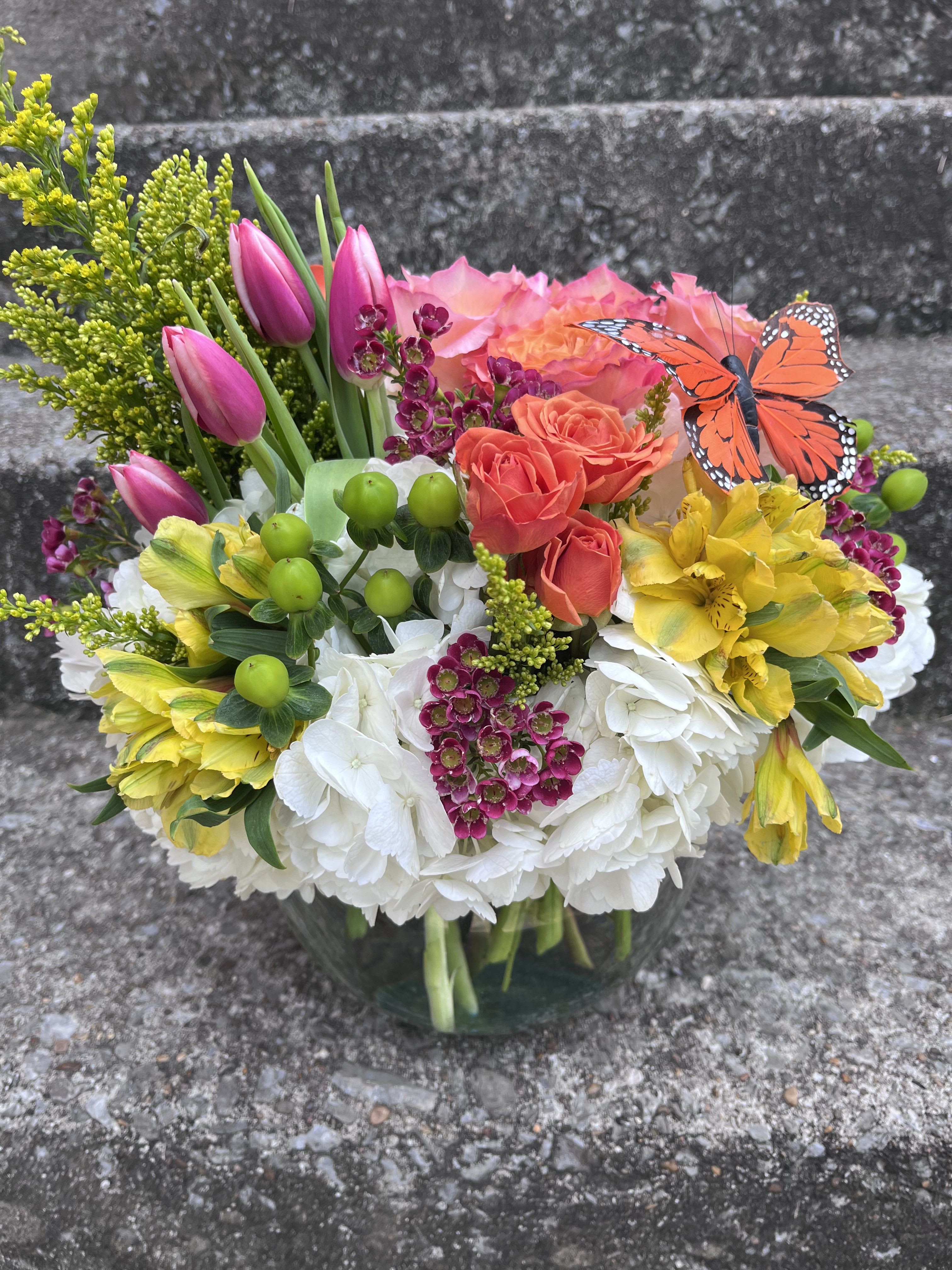 Garden Of Eden Garden Of Eden - This arrangement has roses, hydrangeas, tulips, spray, roses, Solidago, wax flower and alstroemeria.