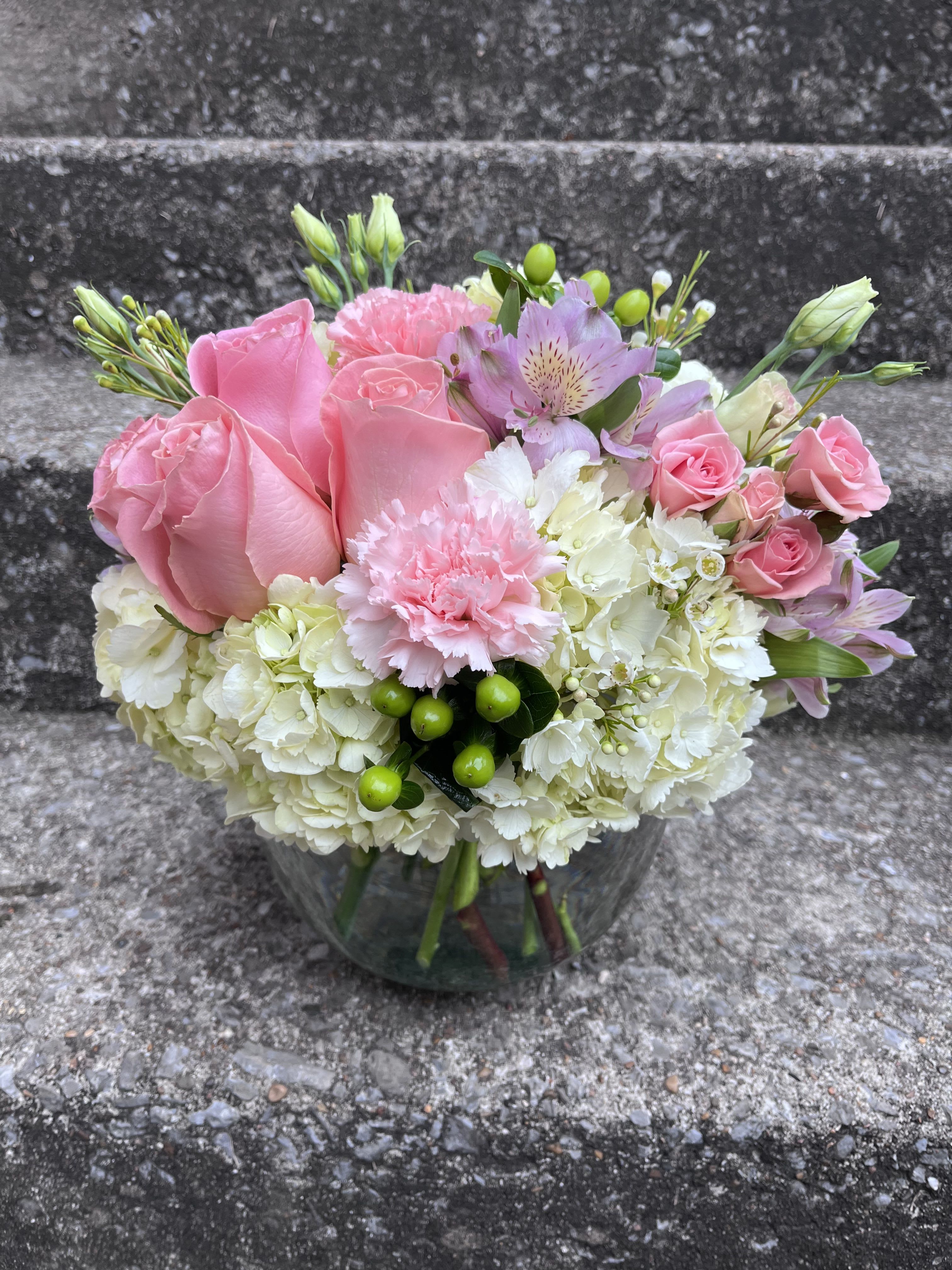 Touch of Lavender  - This arrangement is in a 8 inch bubble bowl filled with hydrangeas, roses, alstroemeria, carnations, lisianthus, spray roses, hypericum and wax flower