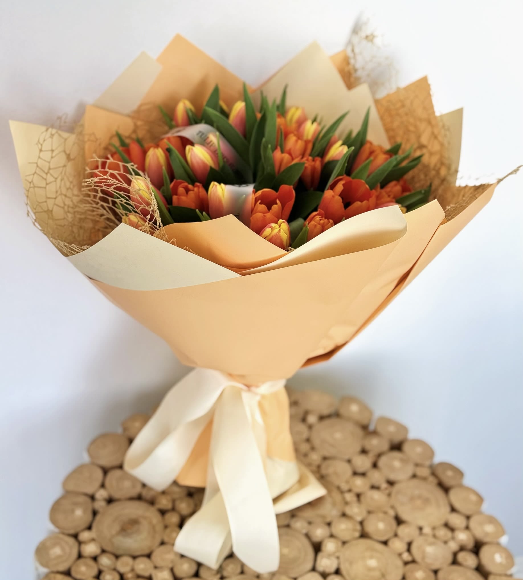 Sunset Tulip Glow  - Bring the warmth of a sunset with this vibrant bouquet of orange and red tulips, wrapped in golden hues. A lively and colorful choice for Mother’s Day flowers, spring birthdays, and congratulations gifts. Fresh tulip delivery available now!