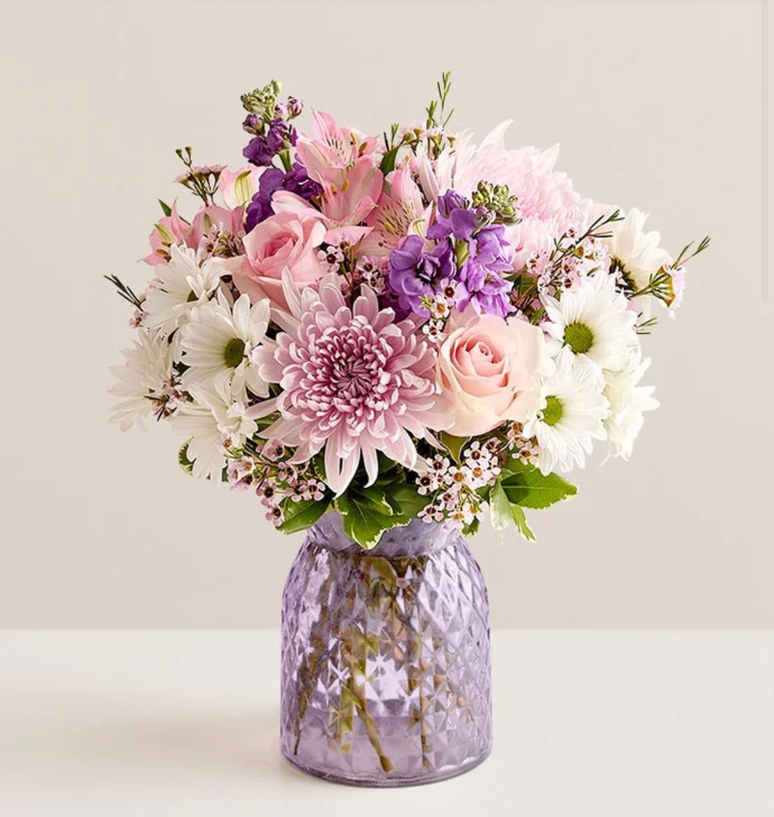 Amazing  Bouquet - NEW Inspired by the beauty of a blooming backyard garden, our bouquet is as amazing as Mom. Our florists arrange roses, Peruvian lilies, and other blooms in a lavender vase that accentuates the beauty of the pink petals. To really light up her day,