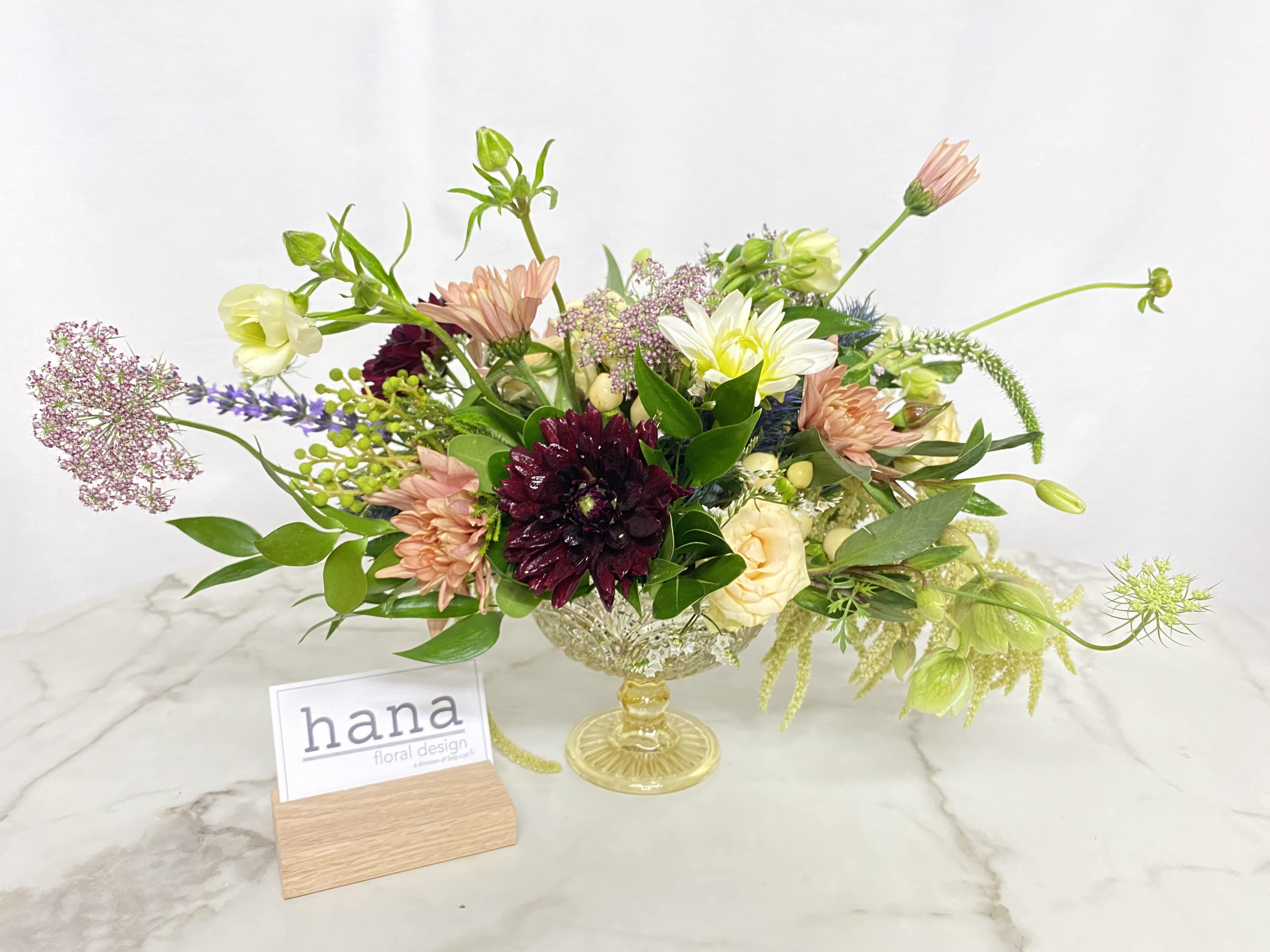 Centerpiece Arrangement in a gold compote  - Designer's Choice  Roses and other flowers 