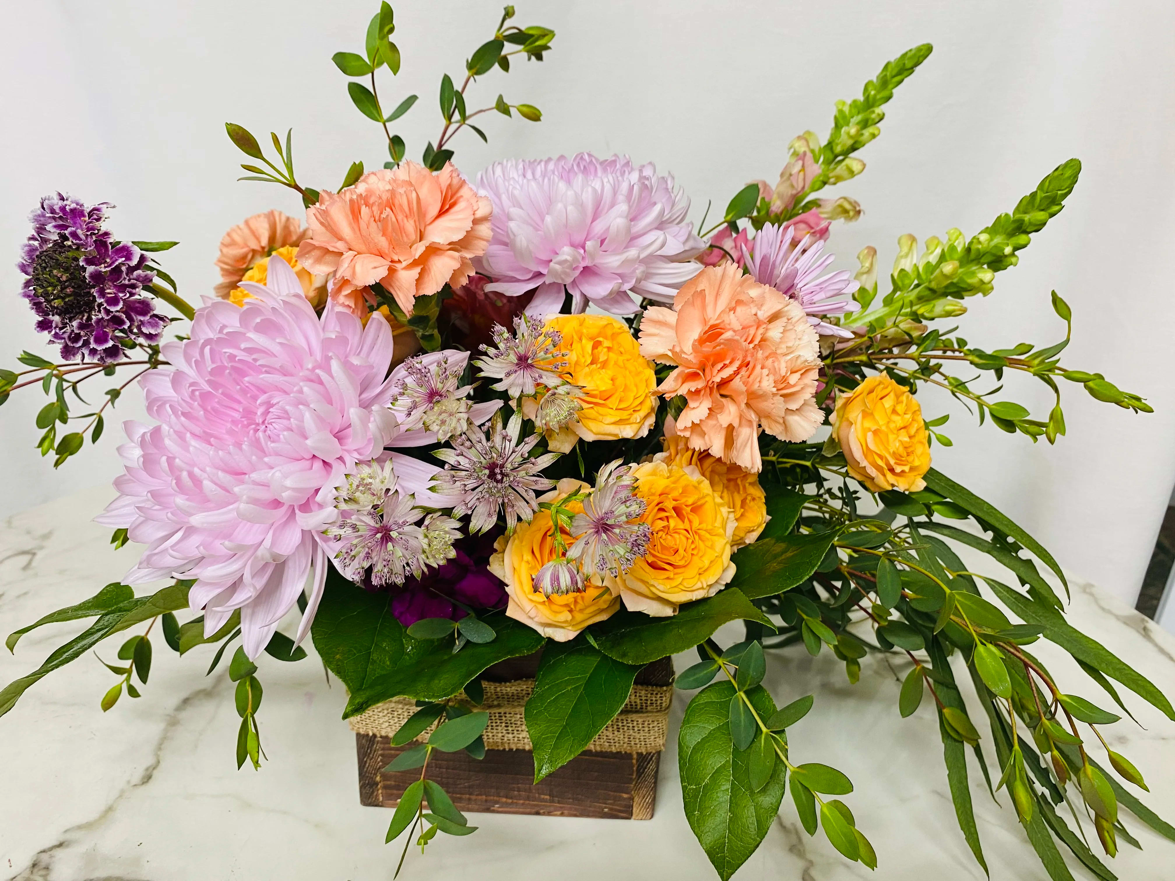 Sweet day Design of the day arrangement in a Wooden Box - The designer will select only the best flowers of the day to create arrangement or bouquet inspired by the seasonal beauty of the flowers.  PLEASE NOTE: The flower selection in the picture is for the design sample and to represent the sizes. The selection of the the flower and color schemes will vary due to seasonal availability.  Please order 48 hours in advance.  