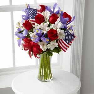 Memorial Day Arrangement Memorial Day Arrangement - A beautiful tribute to honor the memory of our heroes. A nice assortment of red roses, white alstroemeria & blue iris arranged in a clear glass vase.