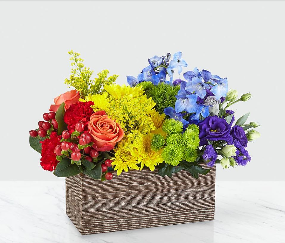Color of Love™ Bouquet - This bouquet is all about capturing the color of your unique love. With a rainbow color pallete, this arrangement has everything from bold reds to vibrant violets, and the all gorgeous hues in between! Our Color of Love Bouquet is made up of a wide array of blooming beauties like carnations, roses, button pompons and more.  