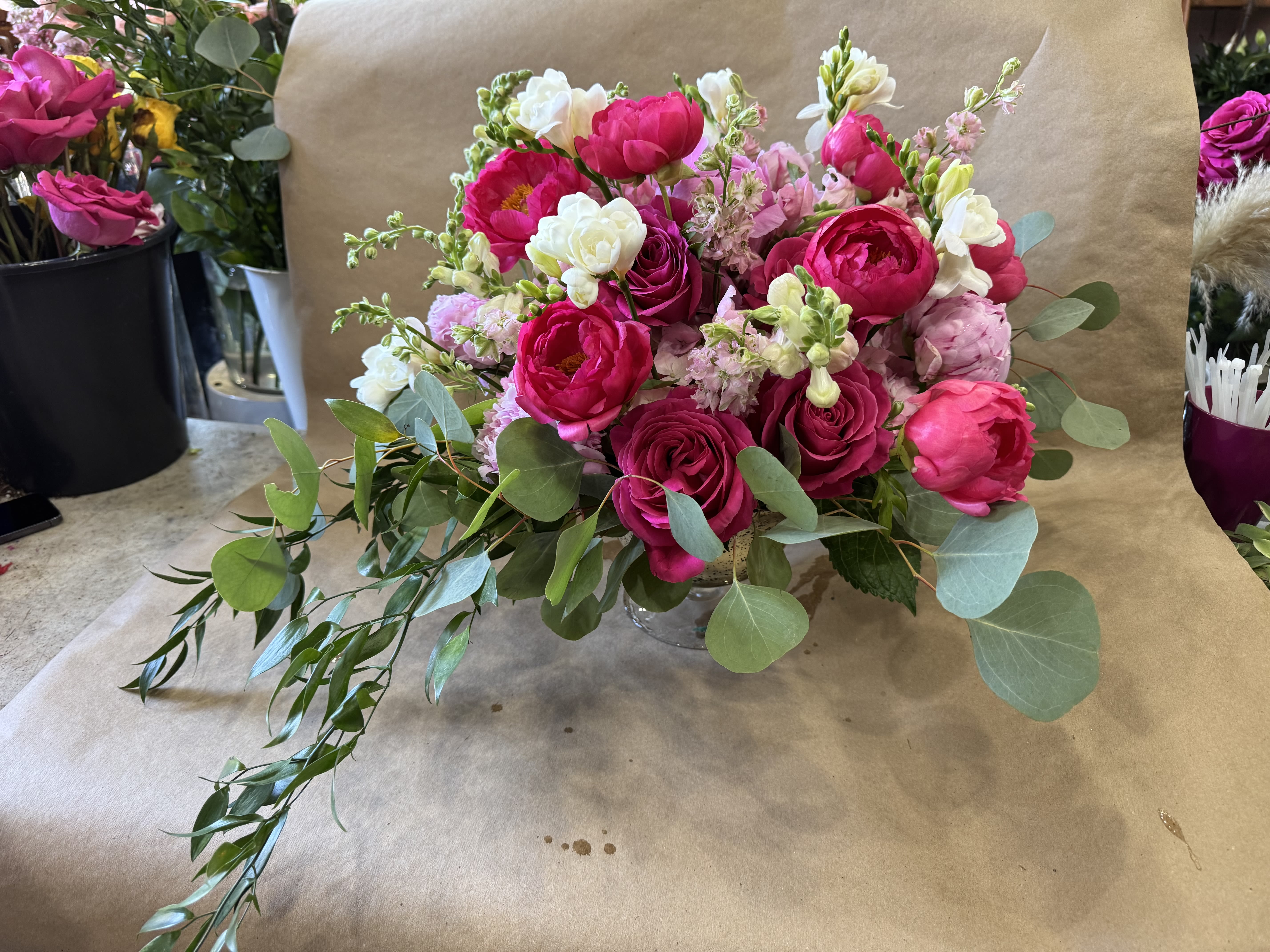 Taking it to the next level - Beautifully arranged floral in slightly elevated glass vase. Filled with beautiful elements such as peony, hydrangeas, garden roses and freesia 