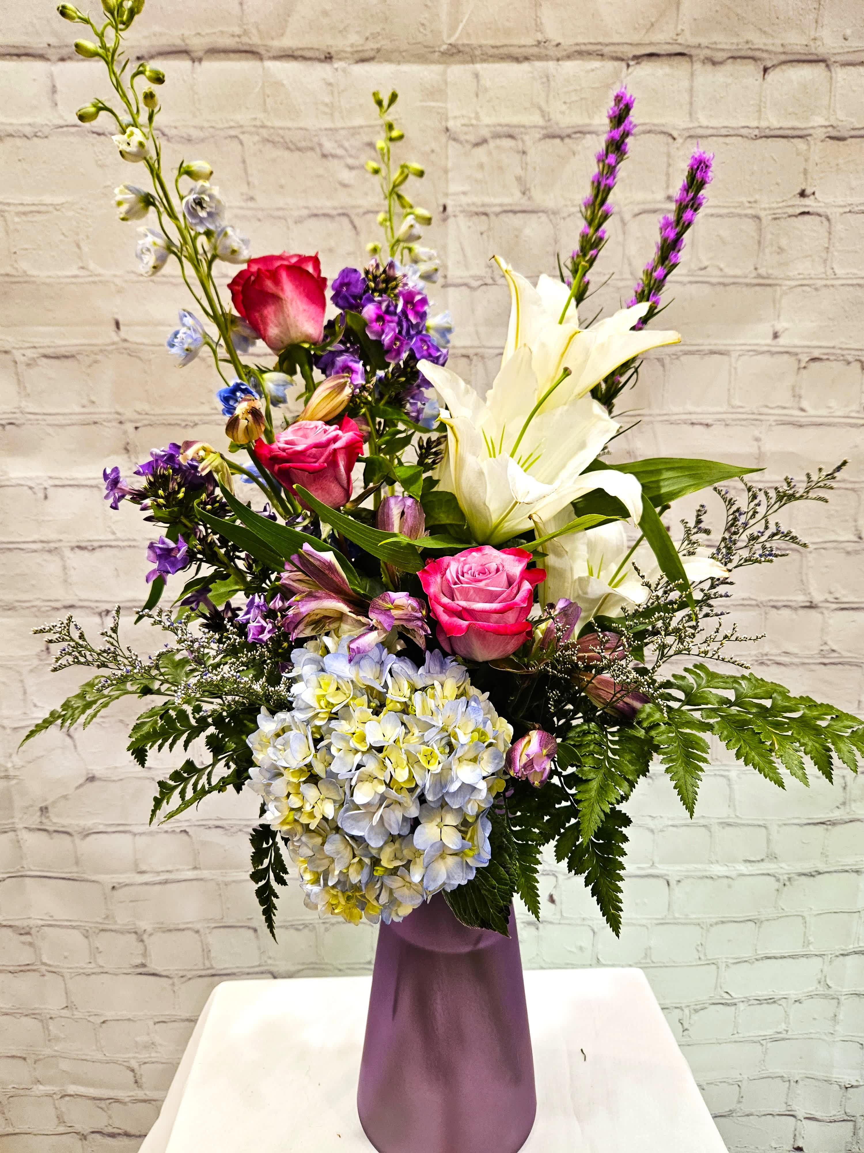 Lovely Lavender Lovely Lavender - A gorgeous mix of lavender blooms and mildly scented flowers. Please note vase color may vary depending on availability. Metcalfe exclusive design.