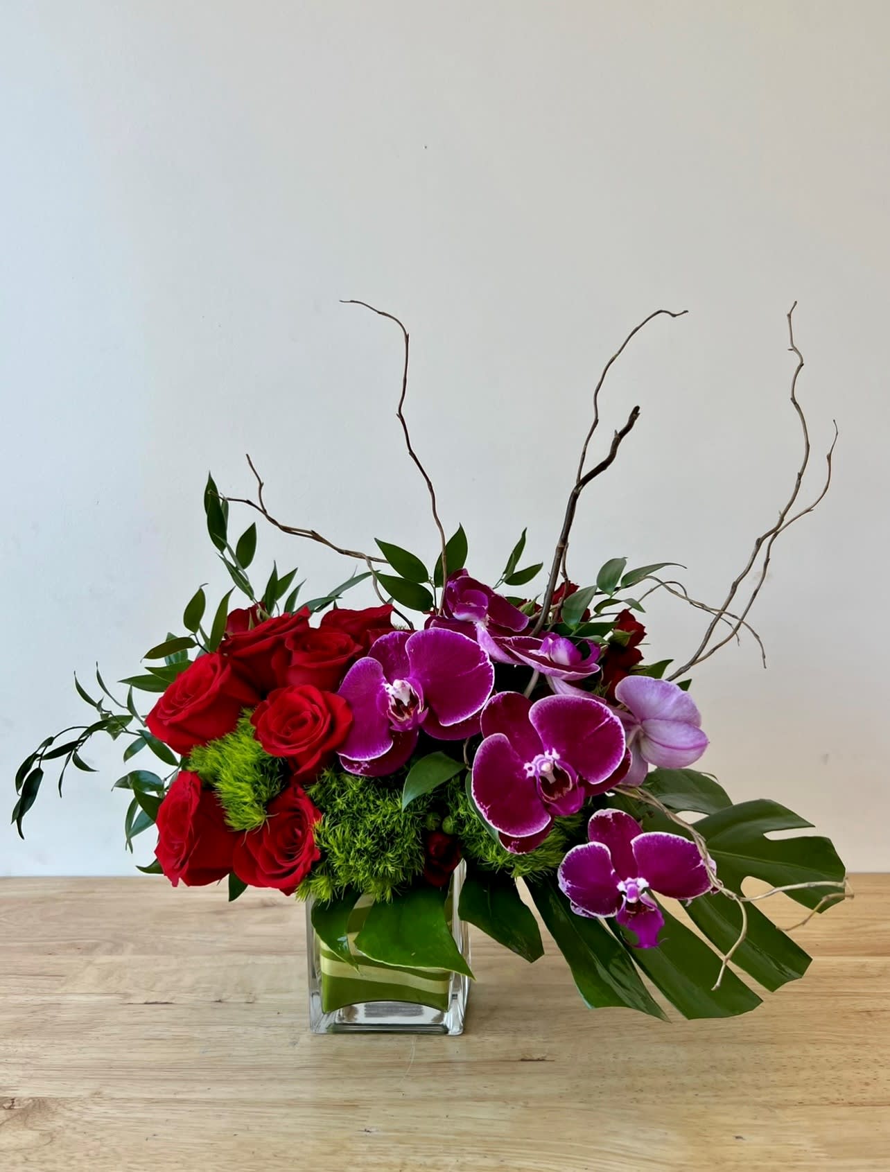 Love Sensation Love Sensation - Gorgeous one-sided arrangement roses, orchids, curly willow, and more.