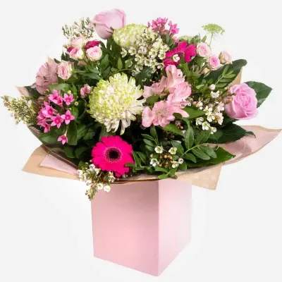 Eternal Charm - Treat your loved one to a bouquet full of elegance and charm. This stunning hand-tied arrangement features soft pink roses, delicate spray roses, bold fuchsia gerbera, pale pink alstroemeria, lush green chrysanthemums, wax flowers, and fresh greenery. Presented in a soft pink gift box, this bouquet is a beautiful expression of love, gratitude, and celebration—perfect for Mother’s Day, birthdays, or just because.  Flowers Included: 	•	Pink Roses 	•	Spray Roses 	•	Fuchsia Gerbera Daisy 	•	Pale Pink Alstroemeria 	•	Green Chrysanthemum 	•	White Wax Flower 	•	Fresh Mixed Greenery  Delicate, fresh, and full of joy—just like her