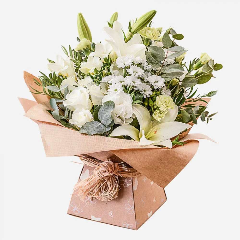 Evelyn - The bouquet in the image features a beautiful and elegant arrangement of various white and green flowers. The flowers used appear to include: 	•	White Lilies (some still in bud form) 	•	White Roses 	•	White Chrysanthemums 	•	Green Carnations 	•	Eucalyptus Leaves 	•	Other assorted greenery and filler flowers  It’s a classic and soft combination, often used for sympathy, weddings, or elegant gifts.