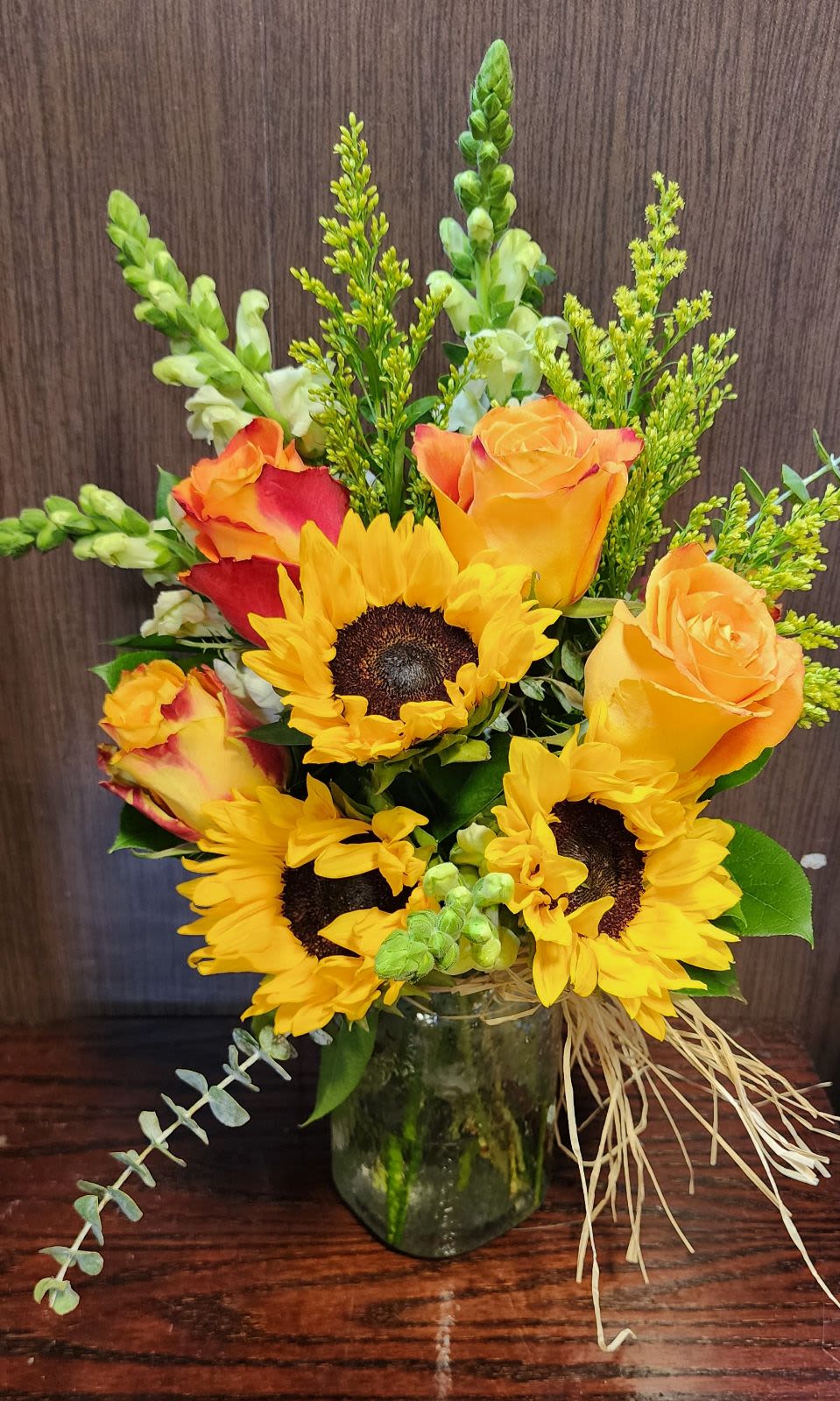 Ray of sunshine Ray of sunshine - larger mason jar with sunflowers, roses, snapdragons, and saladago wrapped with raffia