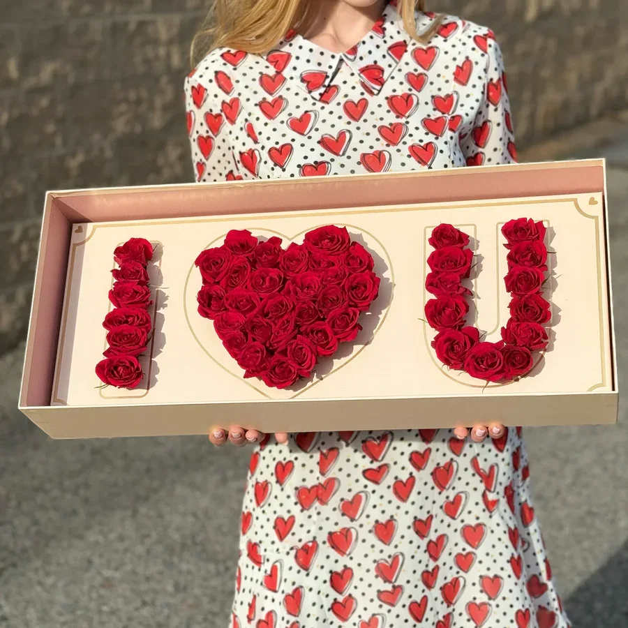 Red Love Box - Add a touch of romance to your special day with Red Love Box featuring a beautiful floral inscription that says &quot;I LOVE YOU.&quot; This charming arrangement blends the warmth of soft pink hues with the timeless message of love, creating a stunning visual that speaks straight from the heart.