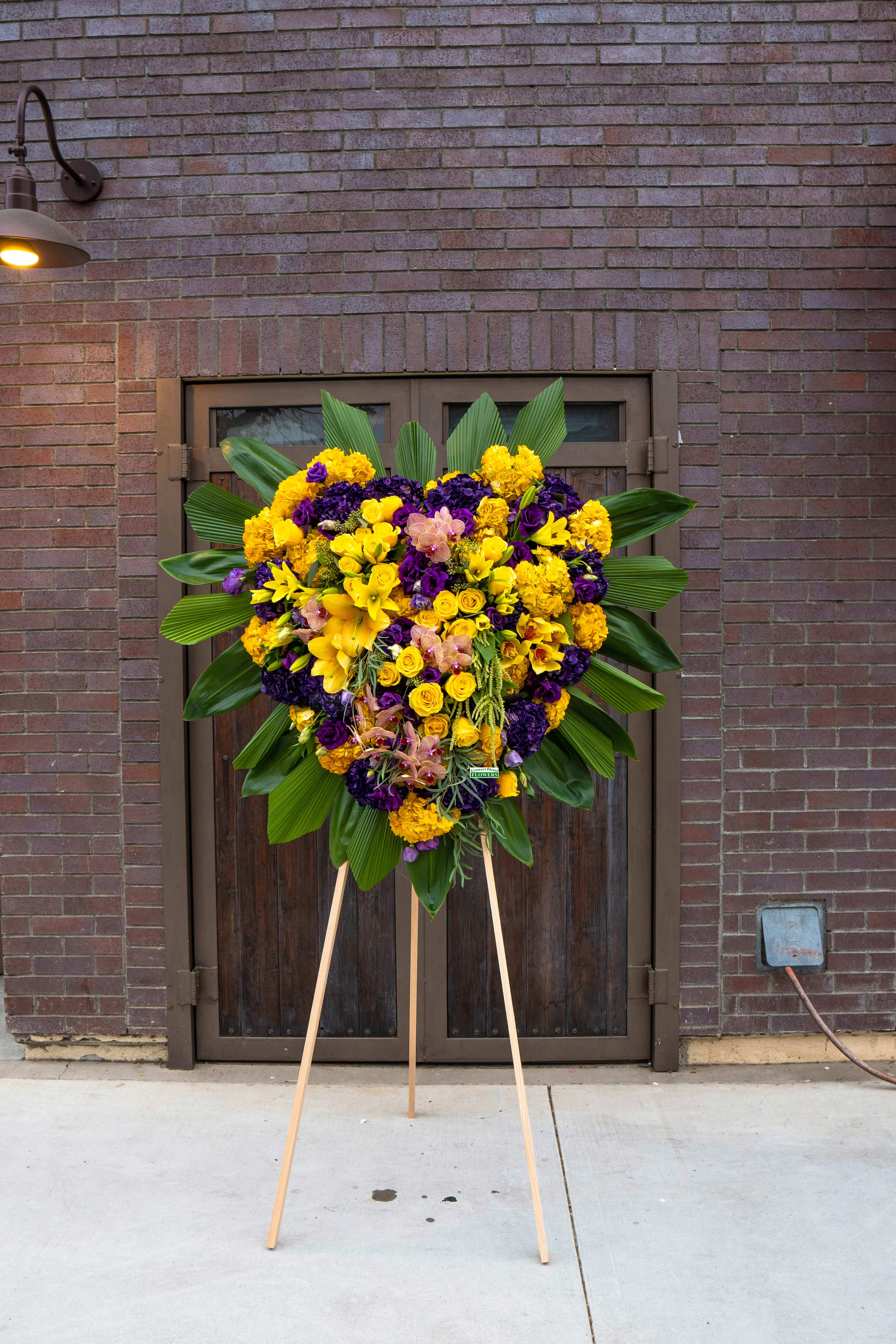 Yellow & Purple Luxury Yellow & Purple Luxury - A beautiful mixture of yellow and purple flowers. The standing spray includes the isle.