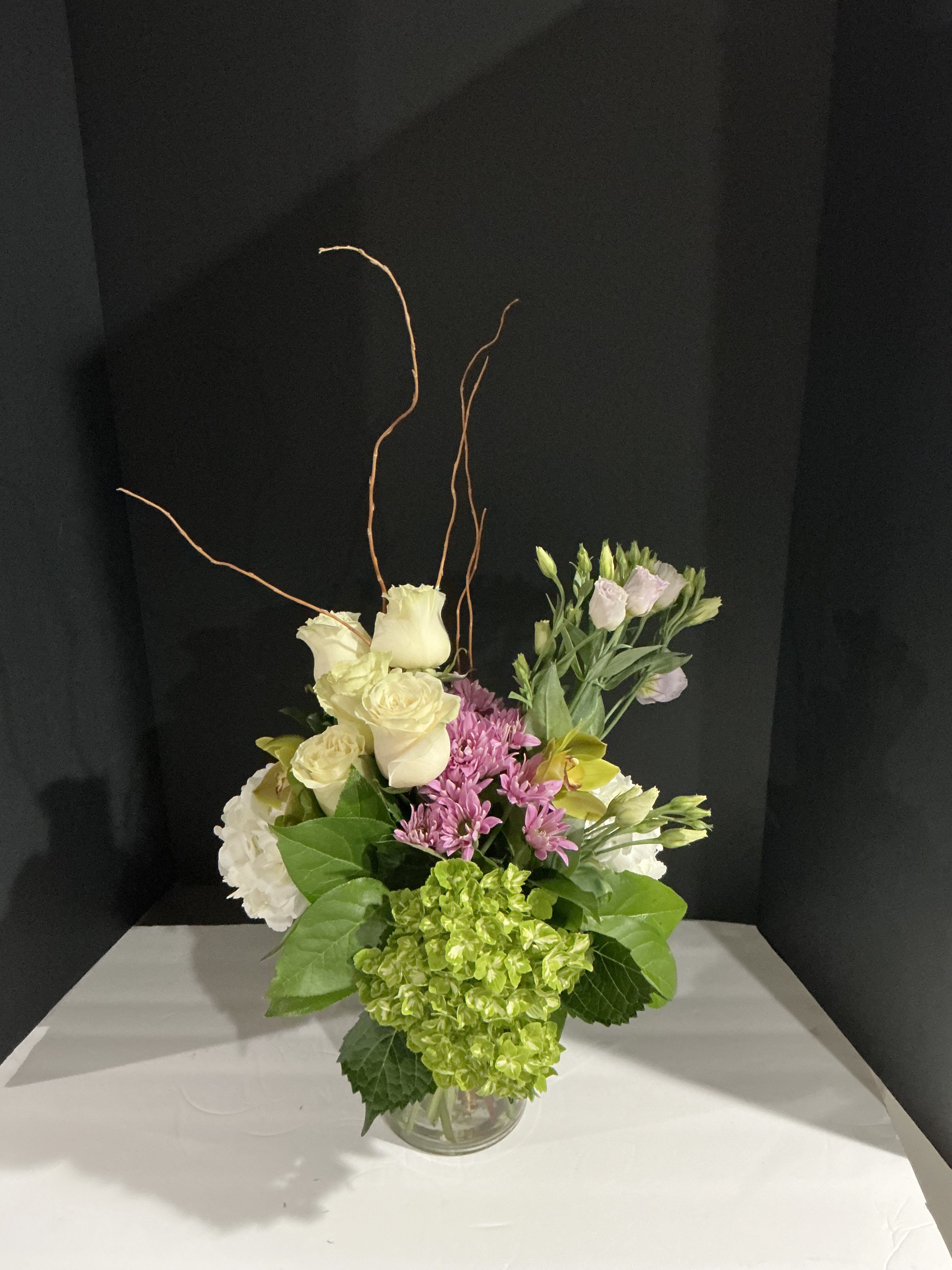 Greenish orchid  - This chic arrangement is exclusive to surprise all special ocassion  Filled orchid,greens,roses,green hydrageas,and more  Approxímate dimensión           18H  15W 